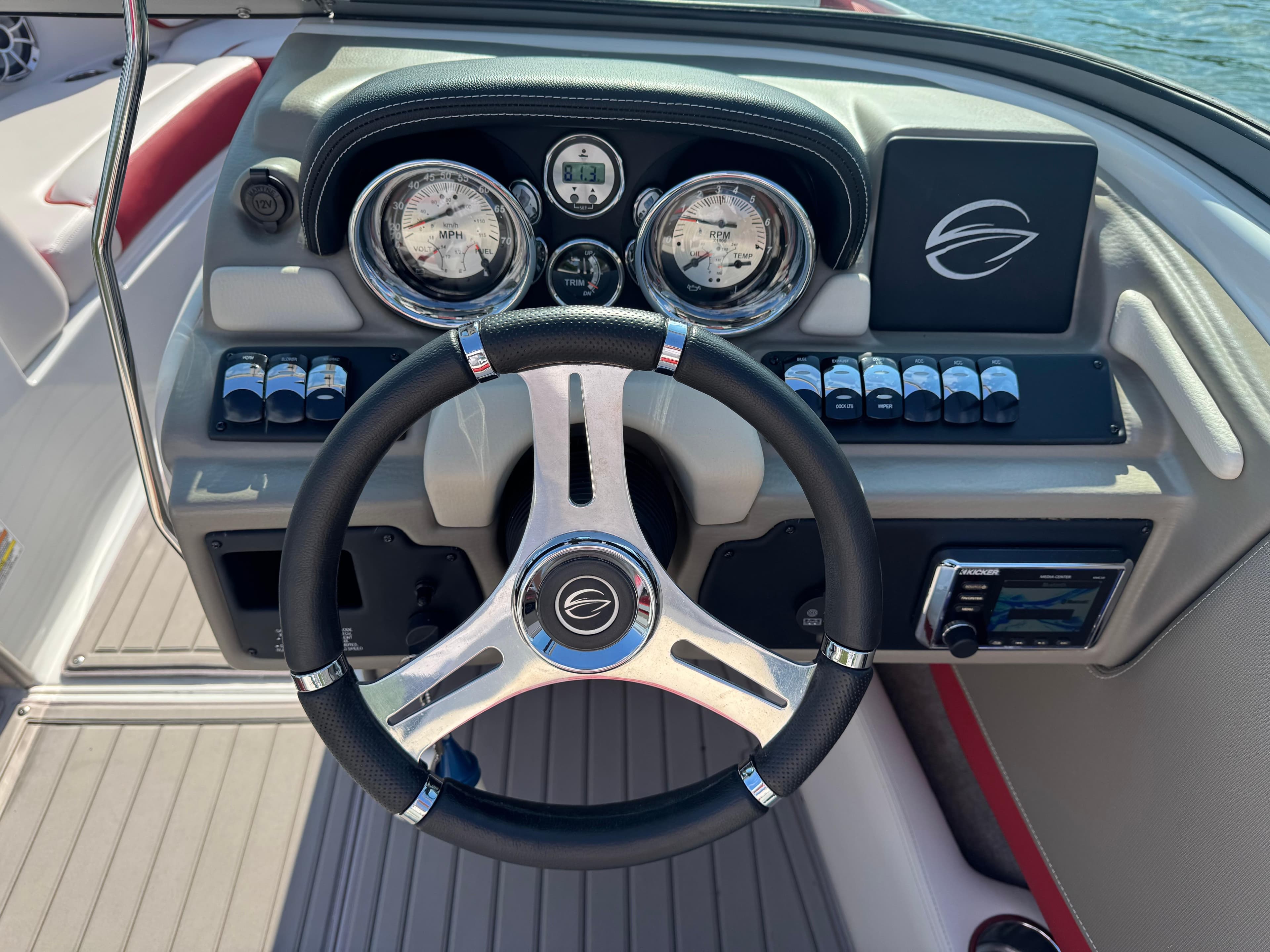Steering wheel and dashboard of 2018 Crownline 225SS boat, featuring gauges and controls.