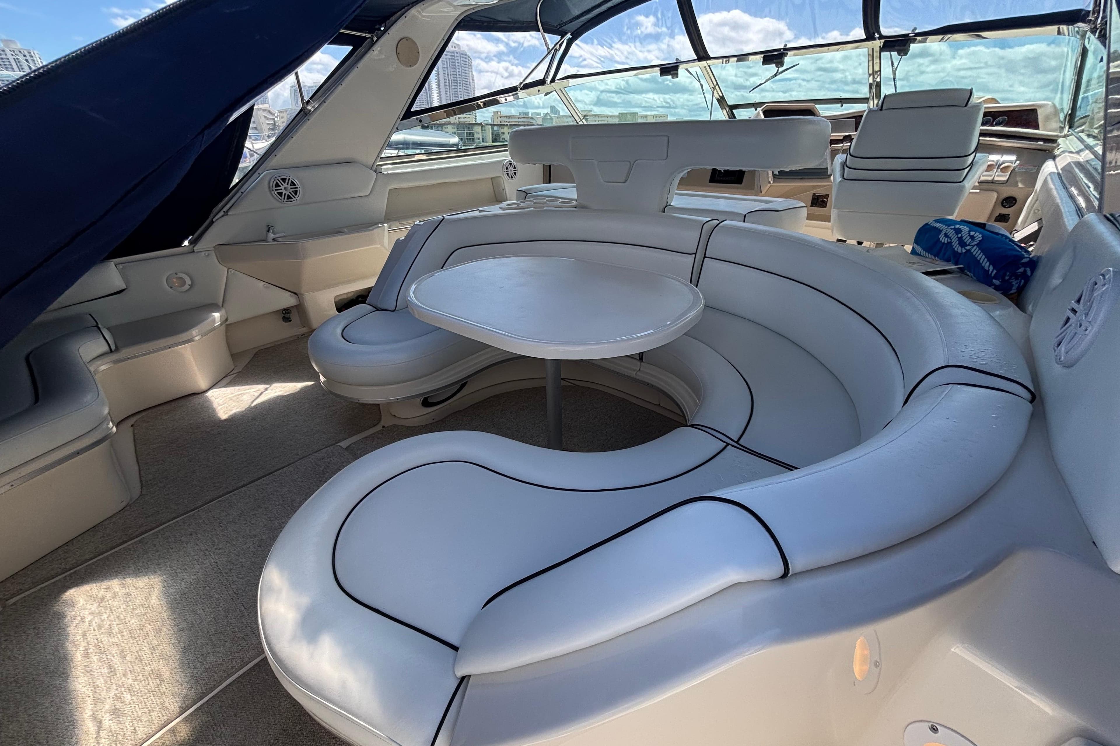 Luxurious interior of 1998 Sea Ray 500 Sundancer yacht with plush seating and table.