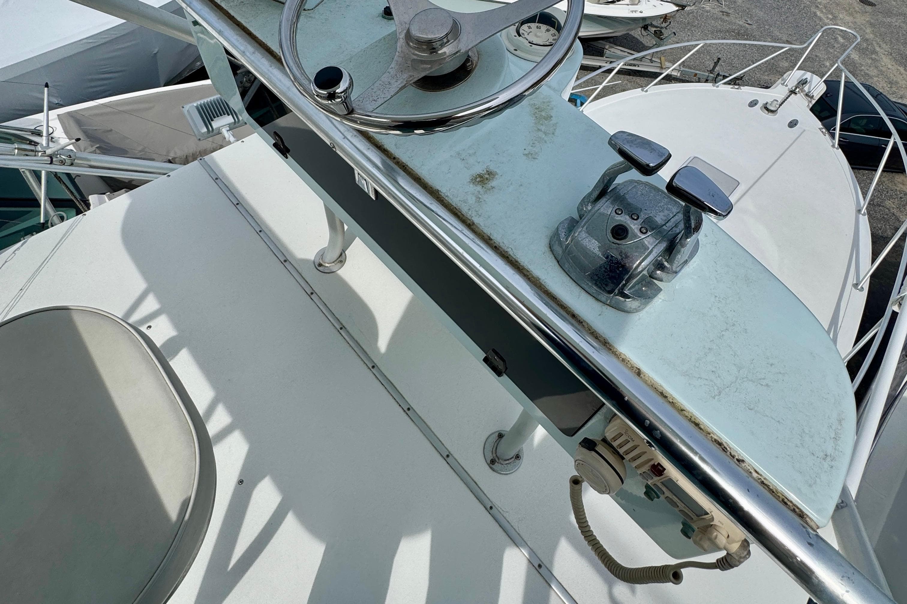2004 Topaz 32 Express boat helm with steering wheel and throttle controls.