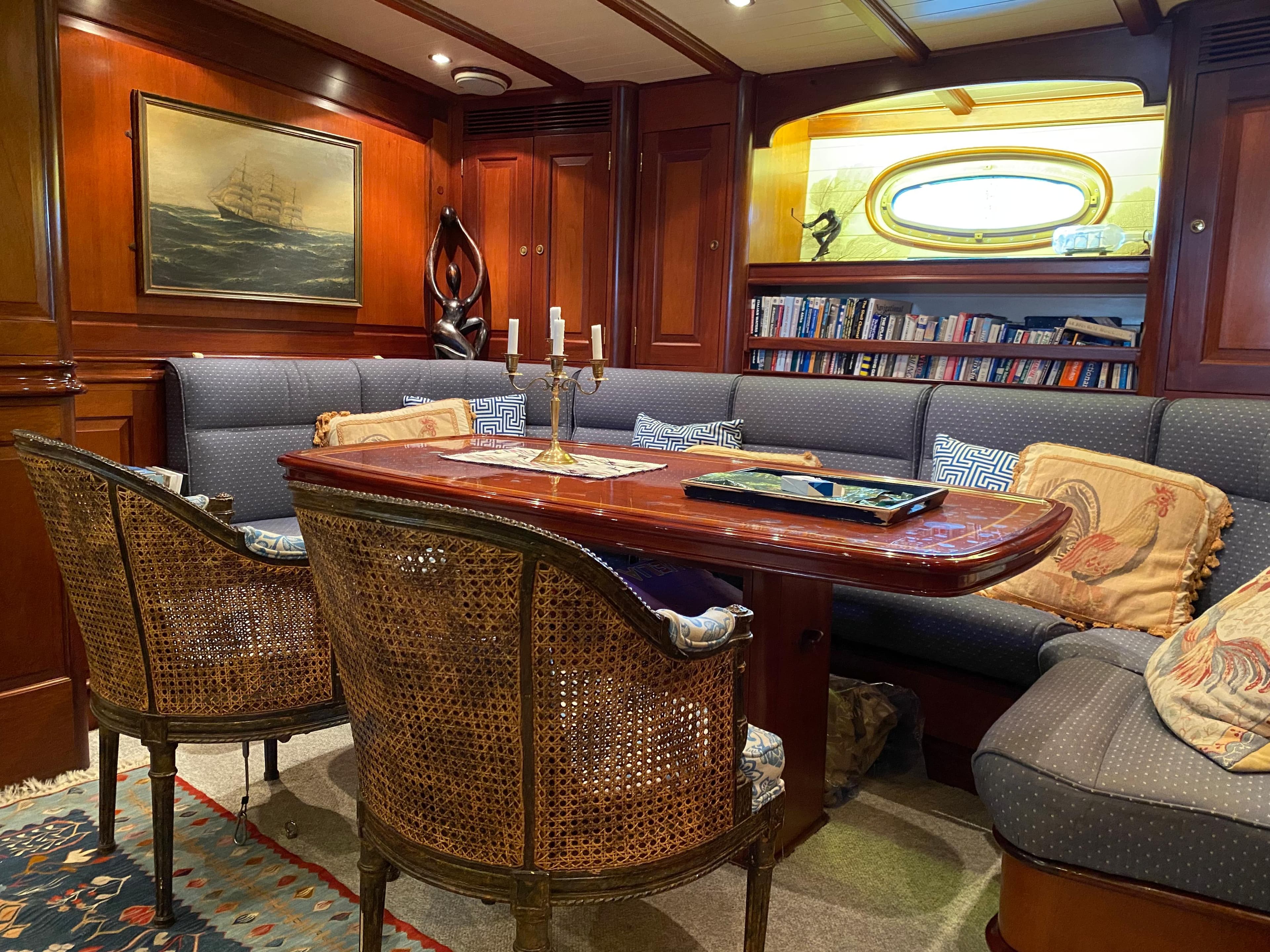 Luxurious 1997 Hoek Truly Classic yacht interior with elegant wood paneling and cozy seating area.