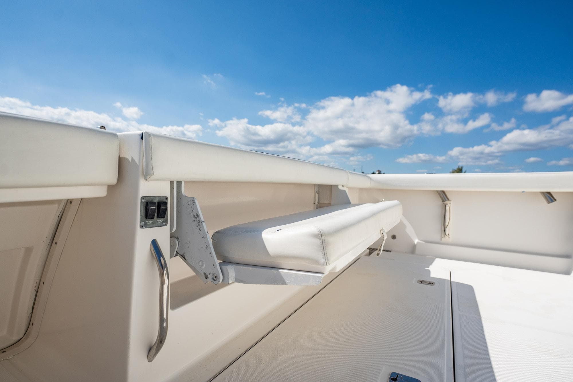 2004 Tiara Yachts 4200 Open deck with seating under clear blue sky.
