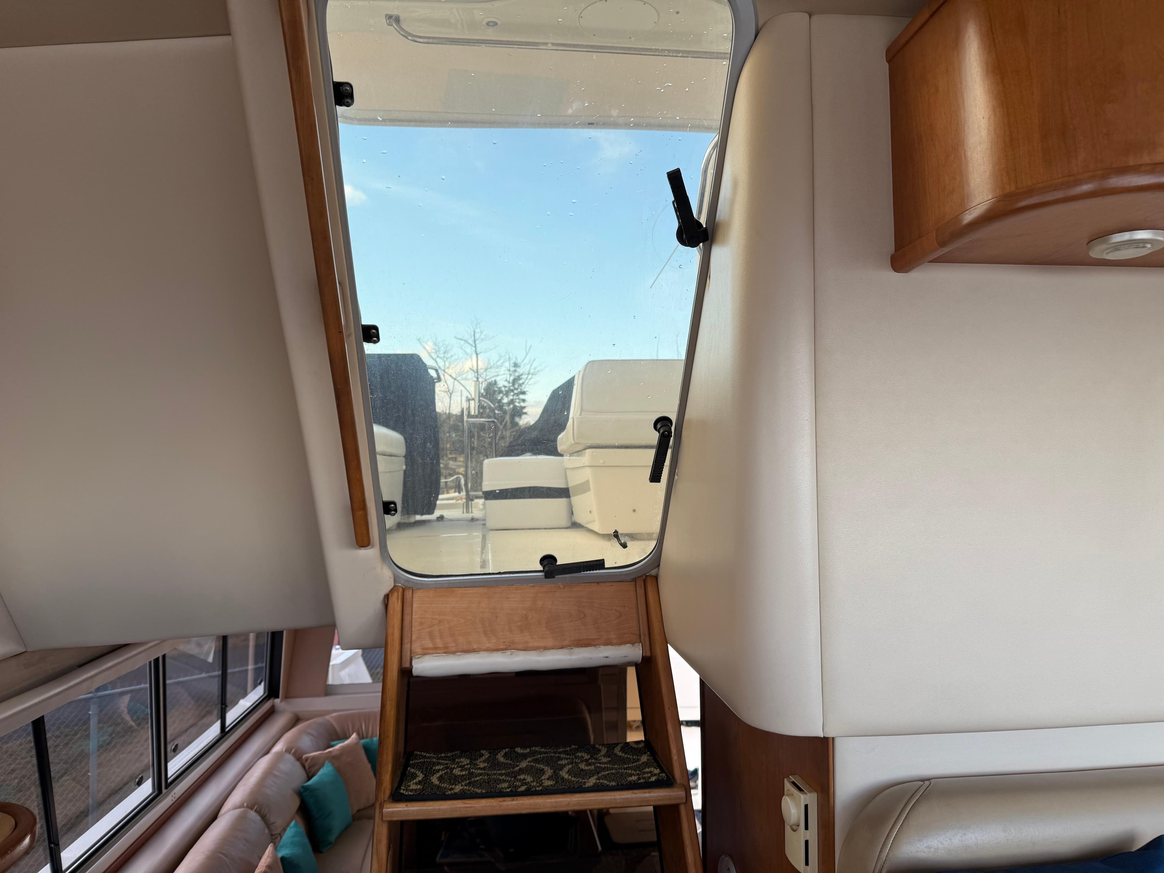 Interior view of 2003 Meridian 490 Pilothouse yacht with stairs leading to upper deck.