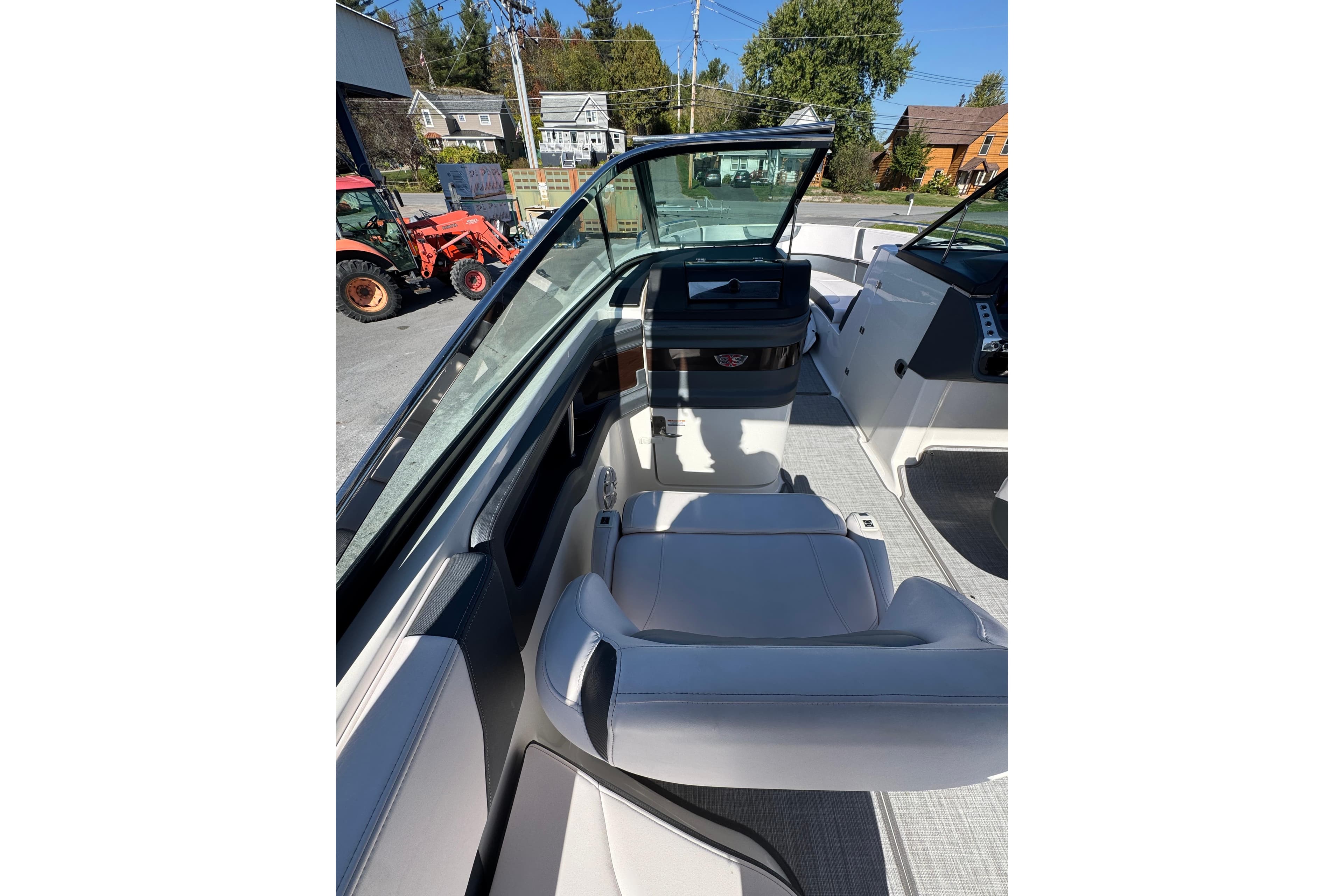 2019 Chaparral 297 SSX boat interior with white seating and dashboard view.