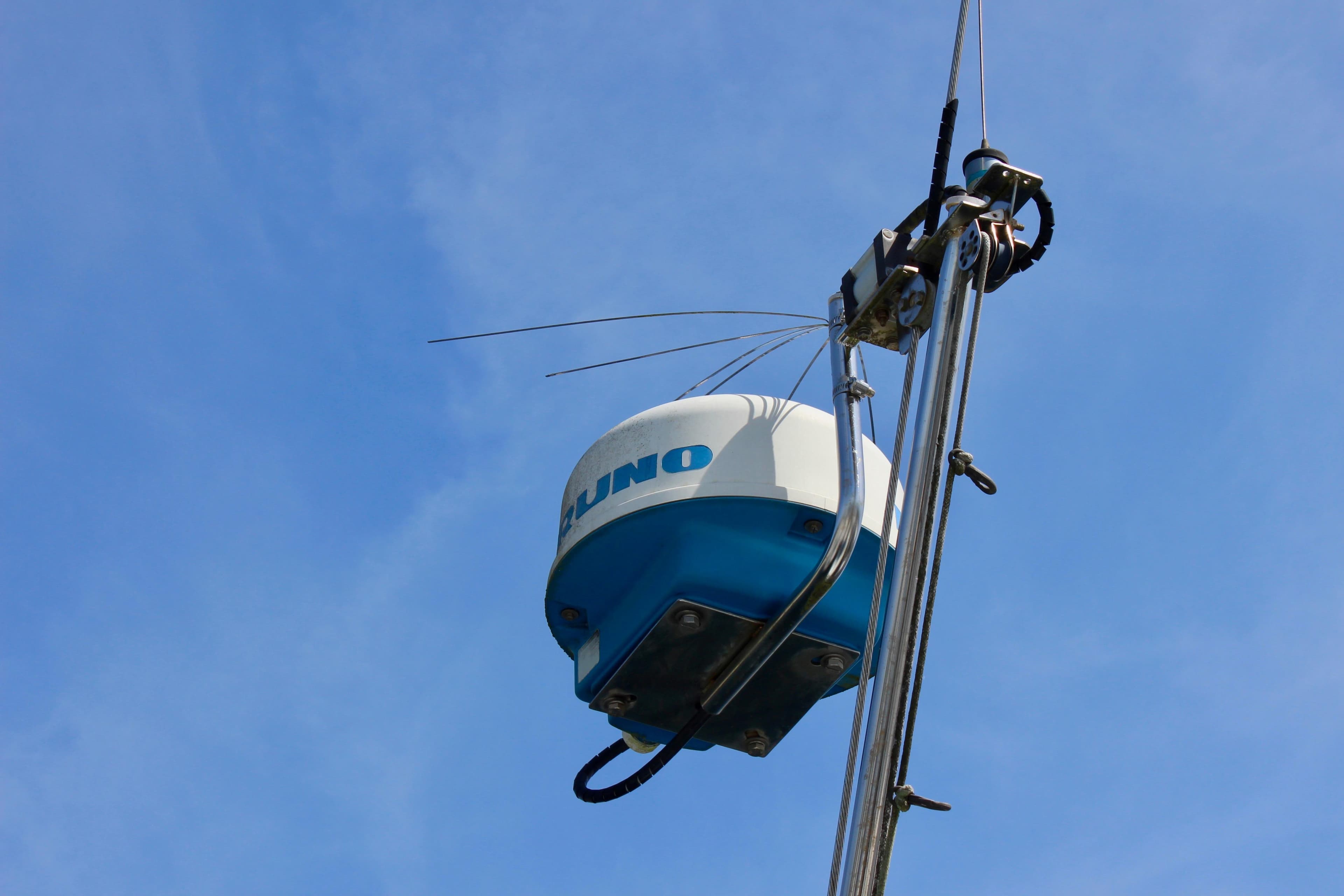 Radar equipment on a Freya 39 sailboat mast against a clear blue sky.