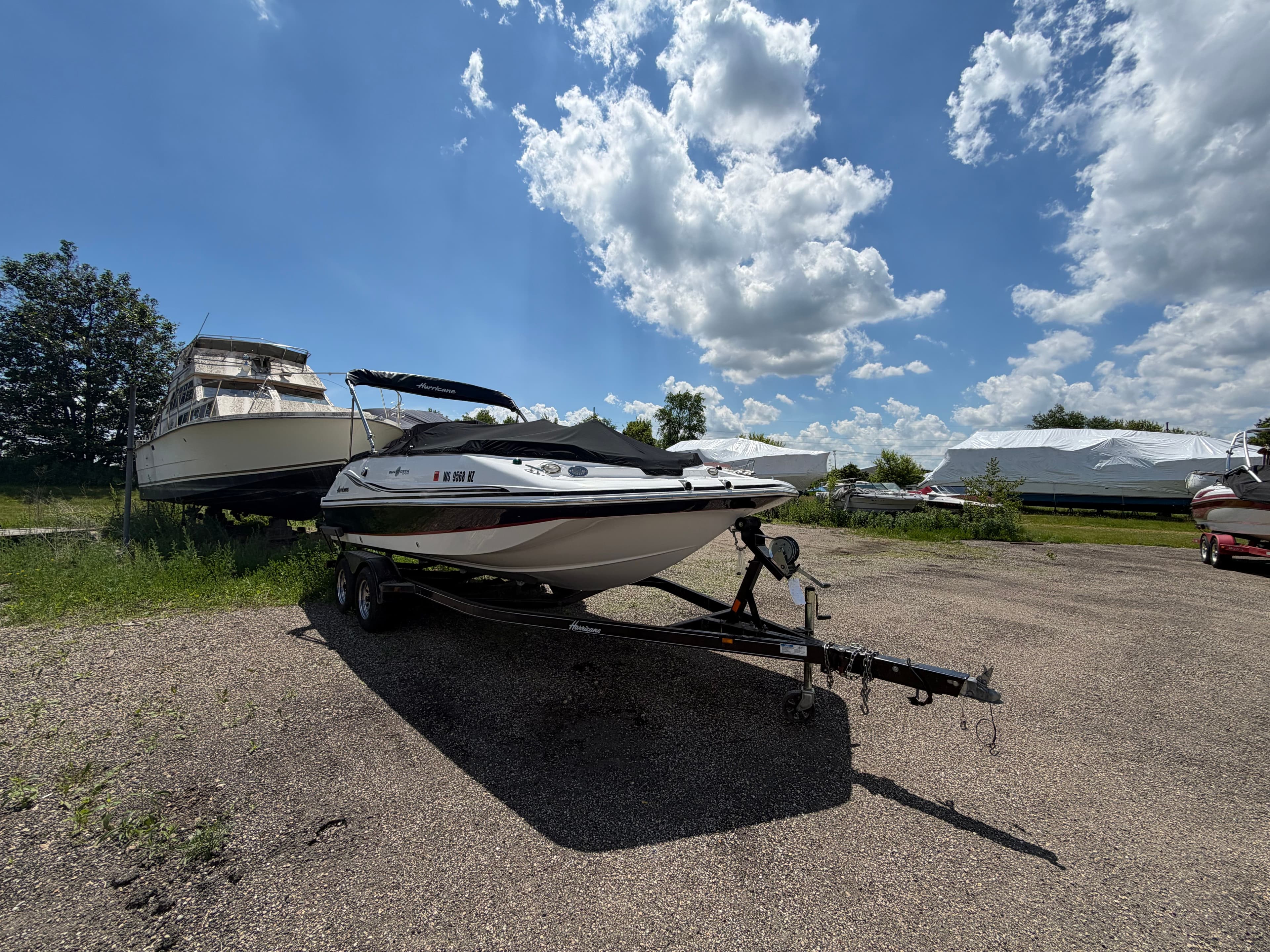 2014 Hurricane 202 Sundeck Sport on trailer under blue sky.