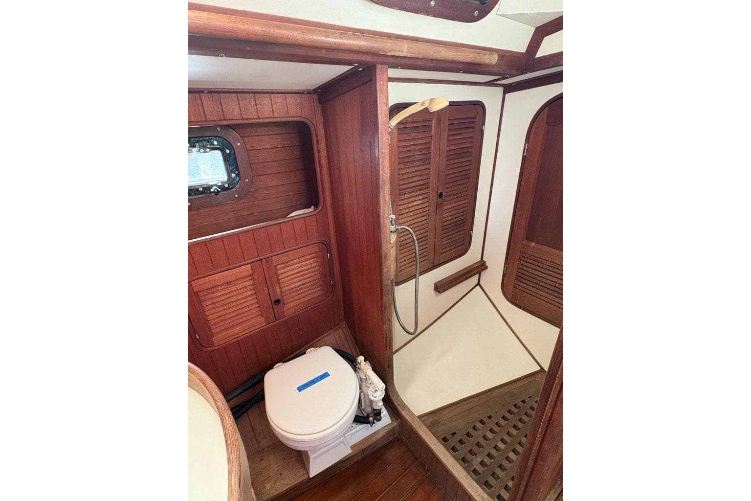 1981 Norseman 447 yacht bathroom with wooden interior and shower area.