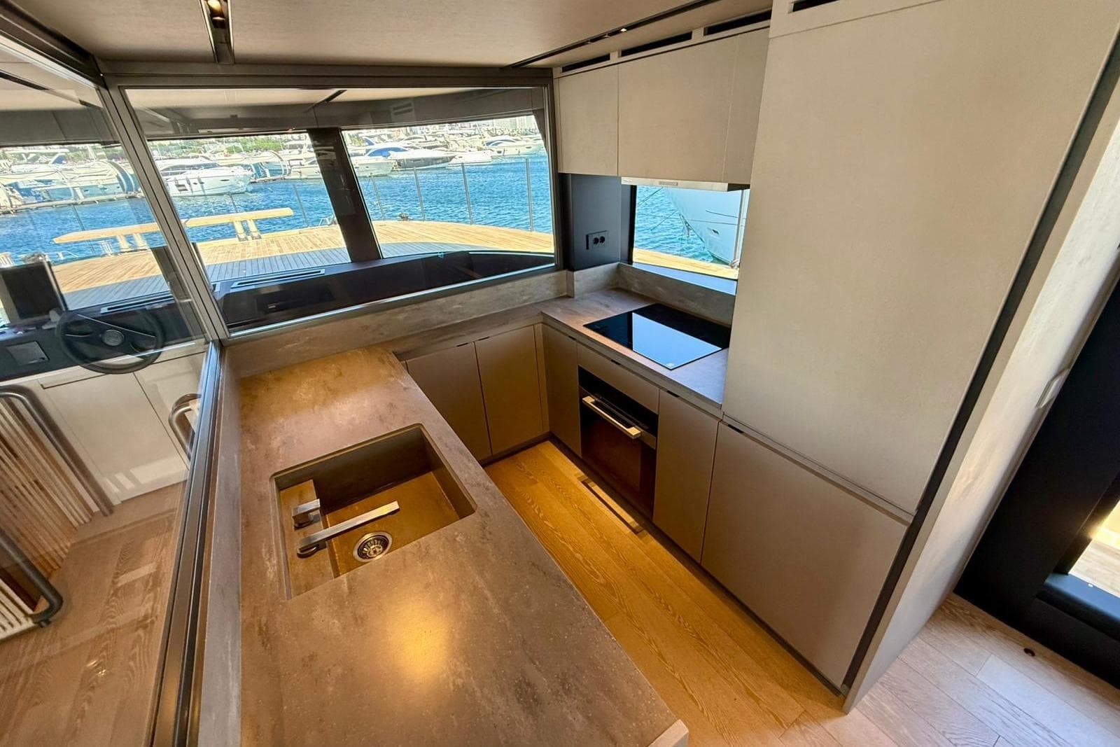 Modern kitchen interior on 2025 Bluegame BGM75 yacht, featuring sleek design and ocean view.