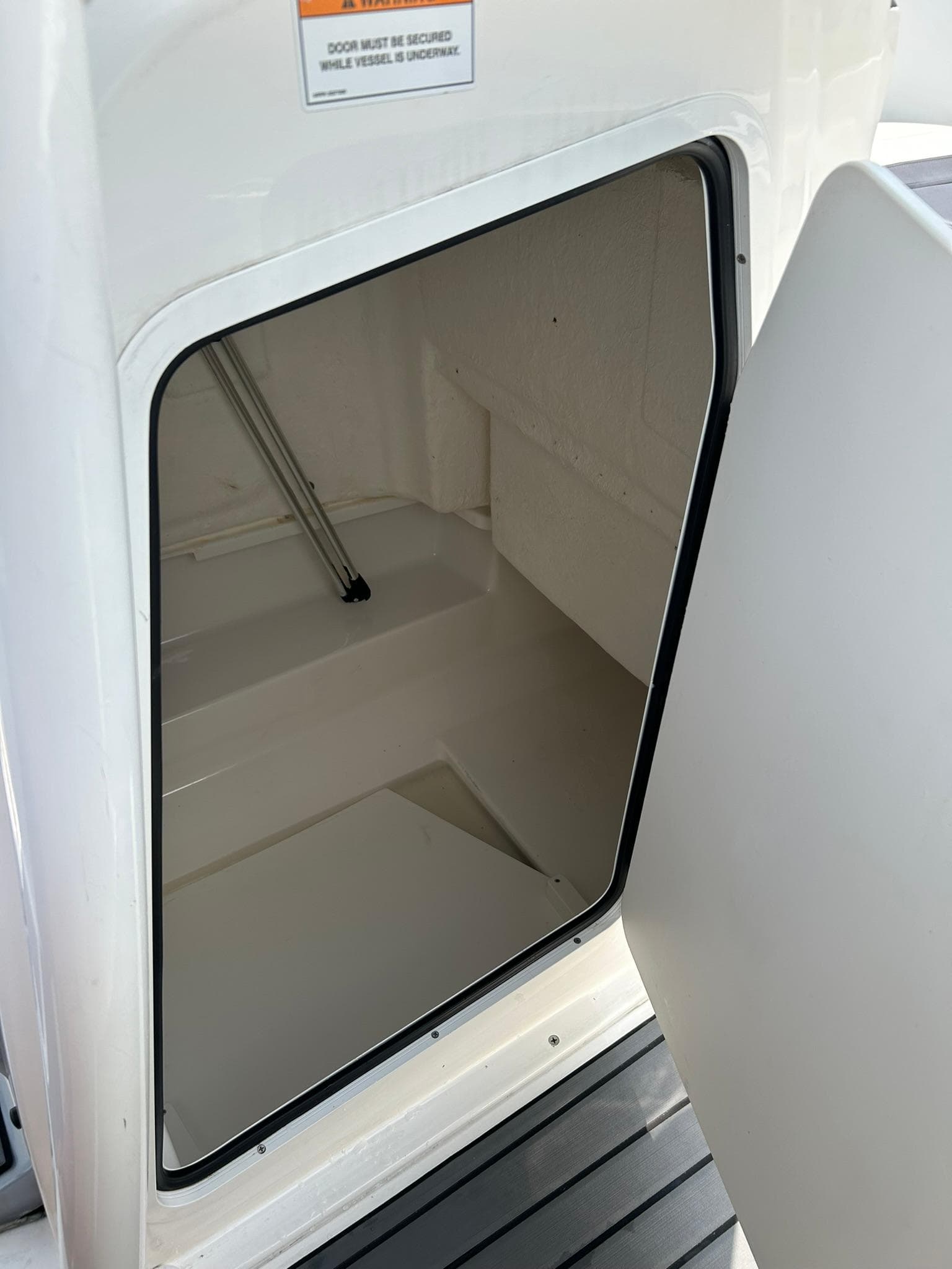 2022 Bayliner Trophy T20CX storage compartment with open door.