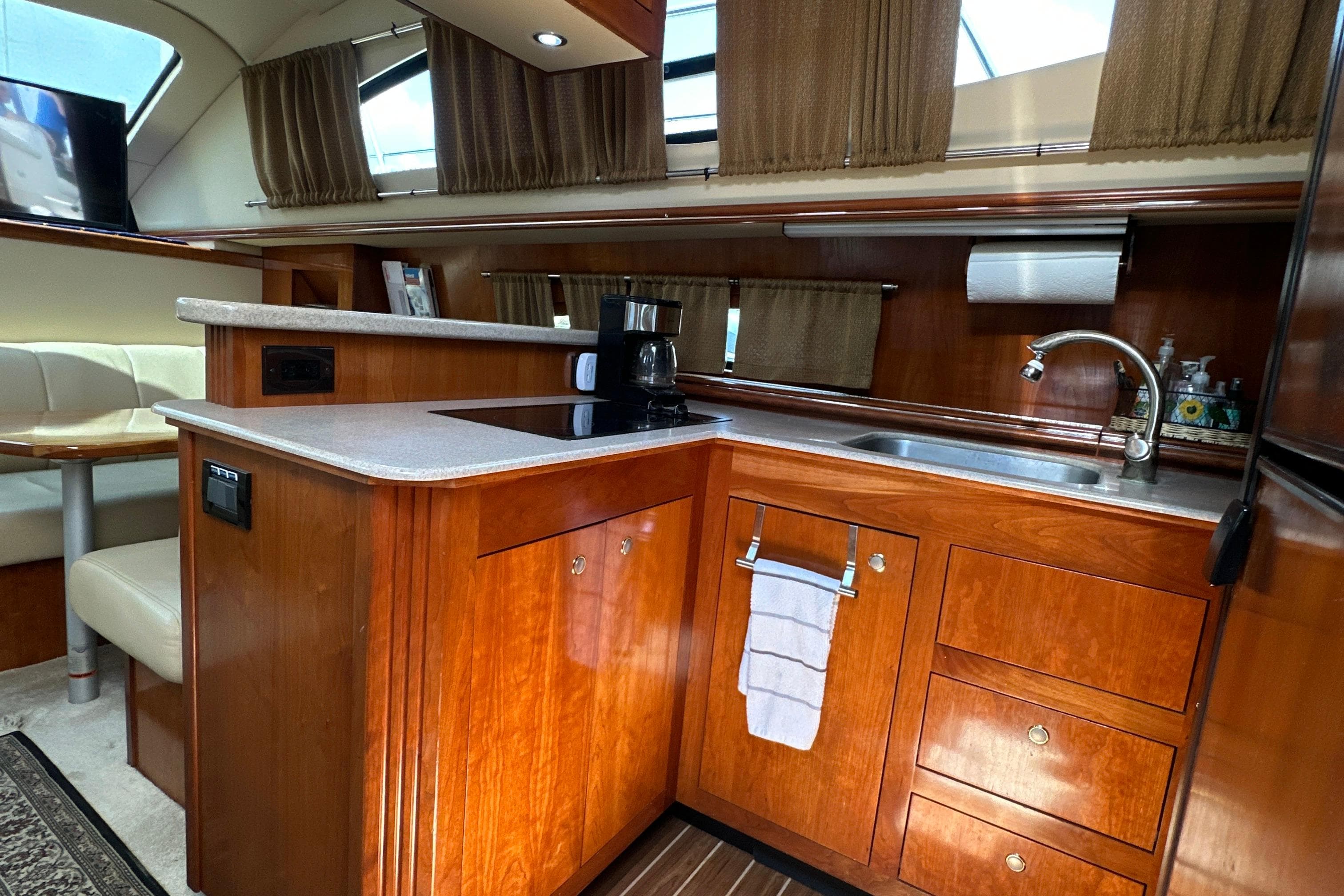 Luxurious 2004 Cruisers Yachts 405 Express Motoryacht kitchen with wood cabinetry and modern amenities.