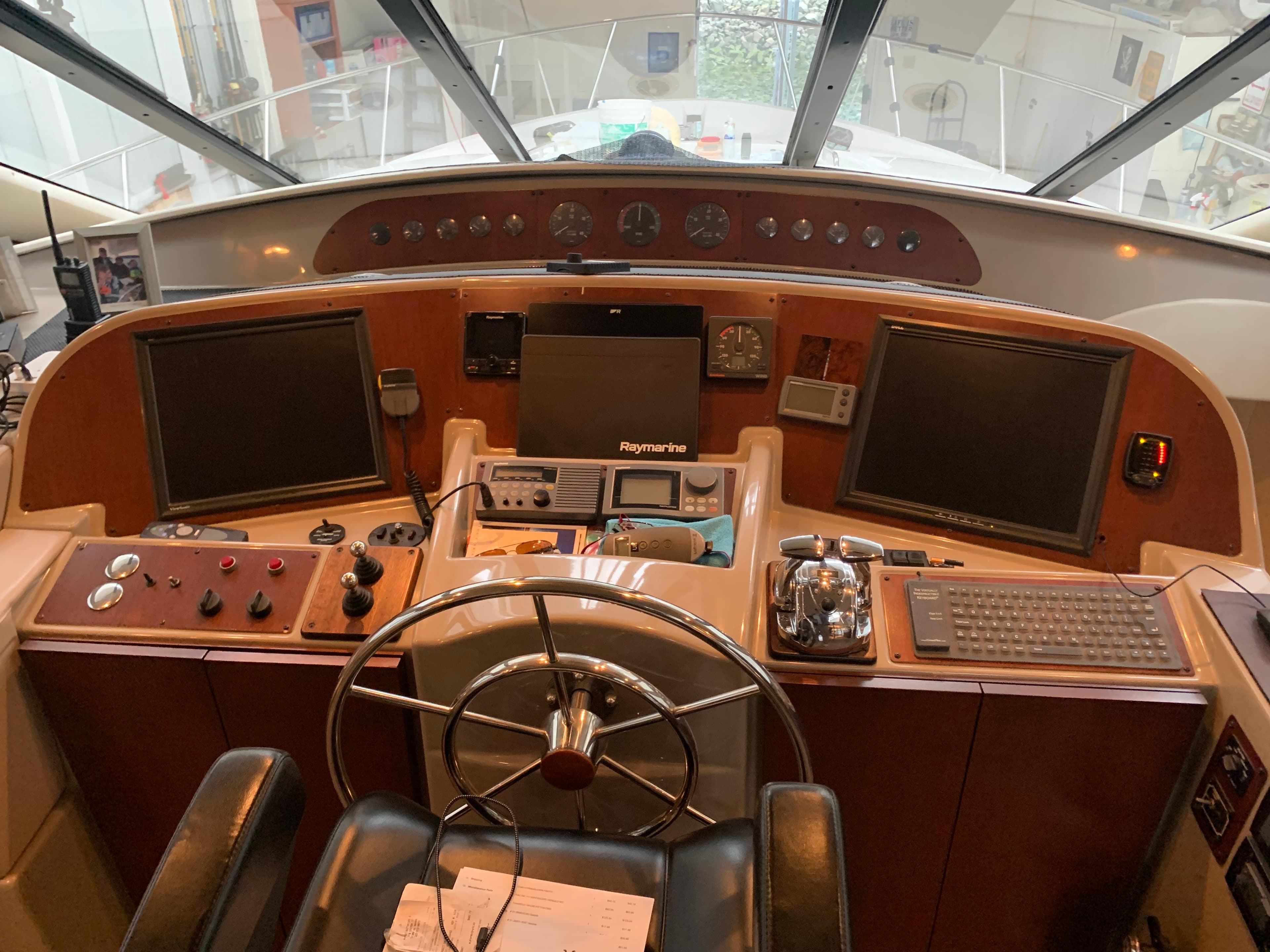 1997 Bayliner Pilothouse helm with steering wheel, navigation screens, and control panels.
