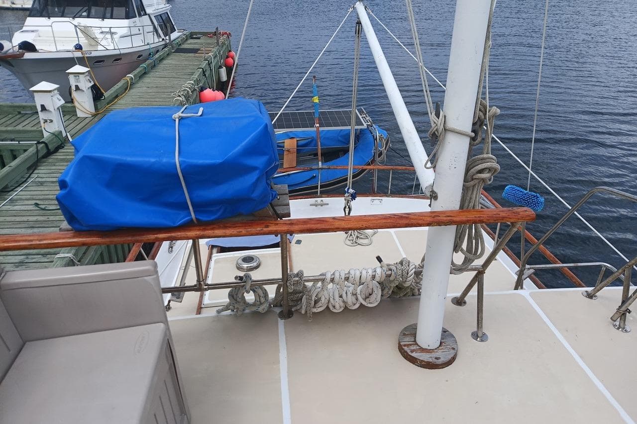 1974 DeFever 40 Passage Maker Trawler Yacht docked, featuring deck ropes and blue cover.