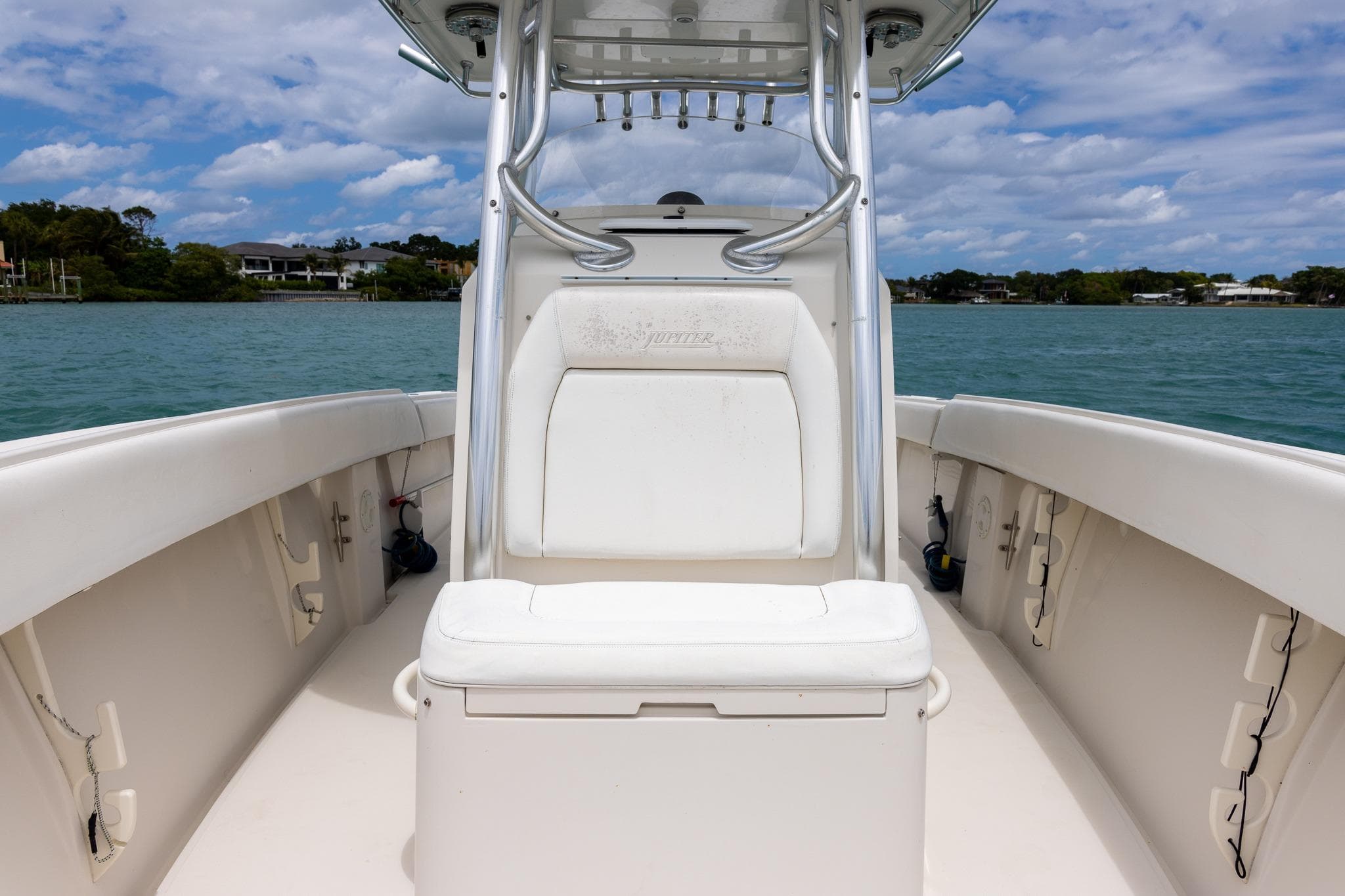 2011 Jupiter 26 FS boat interior with seating, on calm water under a partly cloudy sky.