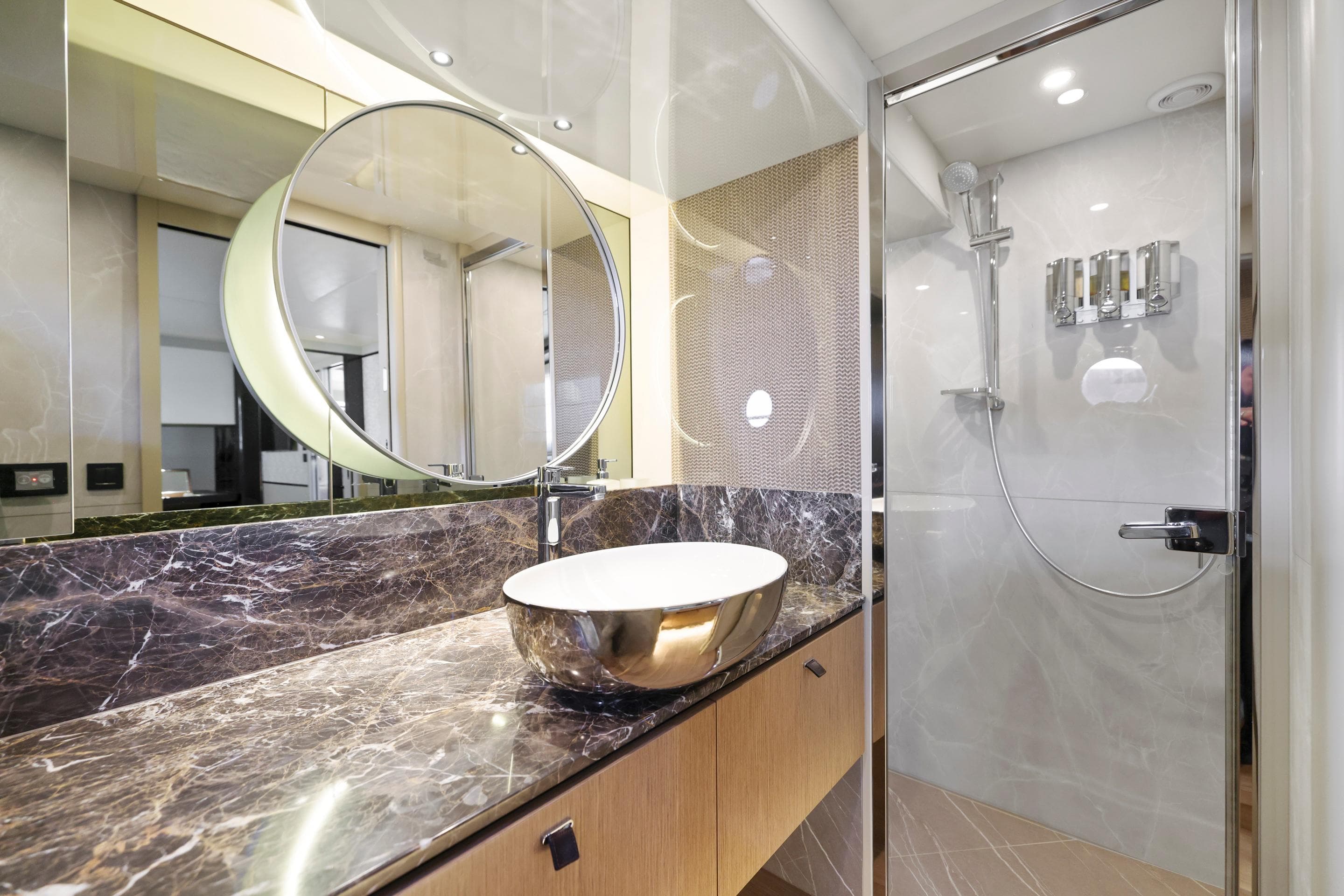 Luxurious bathroom in 2024 Absolute 60 Fly yacht with marble countertop and modern shower.