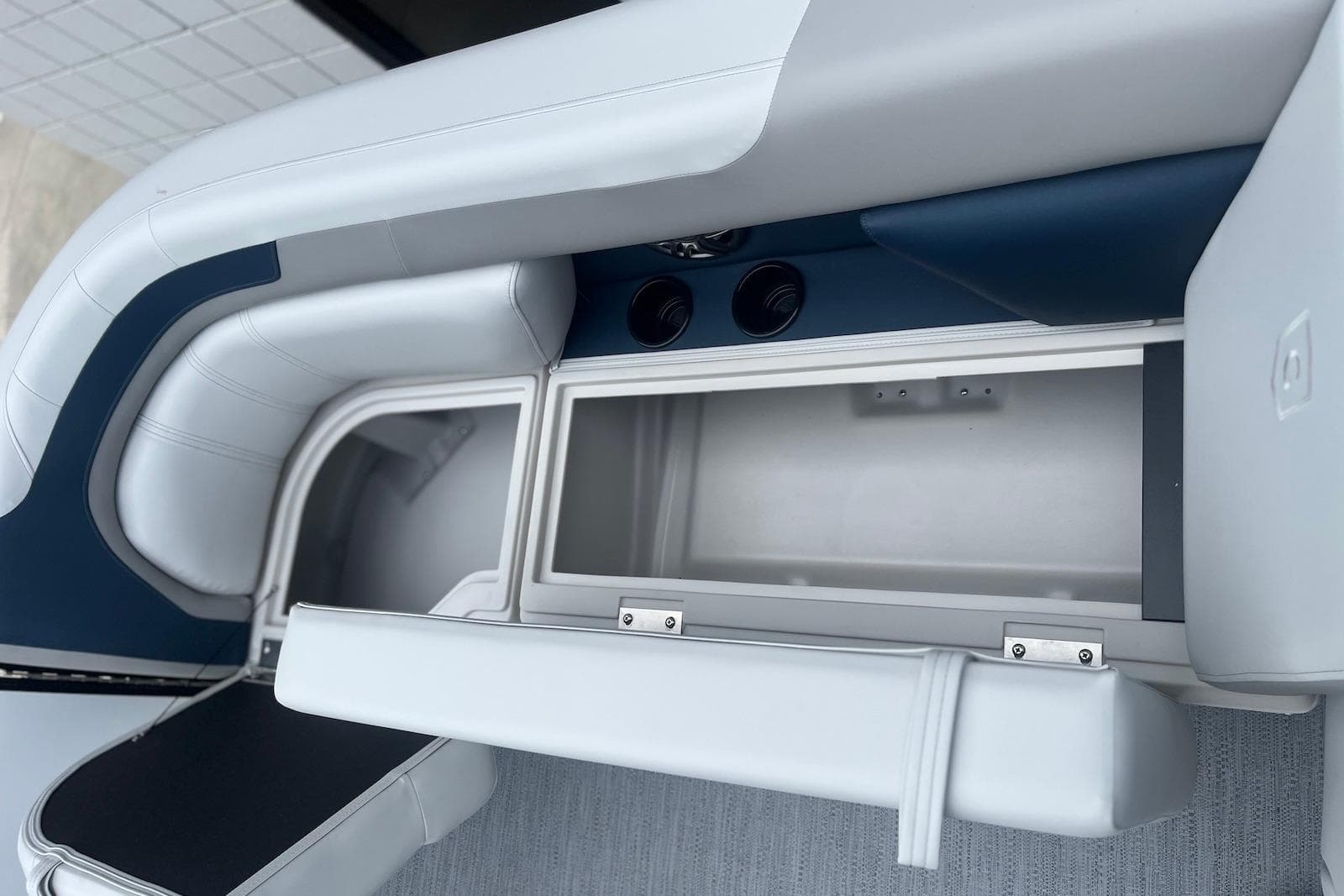 Interior storage compartment of 2026 Godfrey SWEETWATER 2286 SFL boat, featuring cushioned seating.