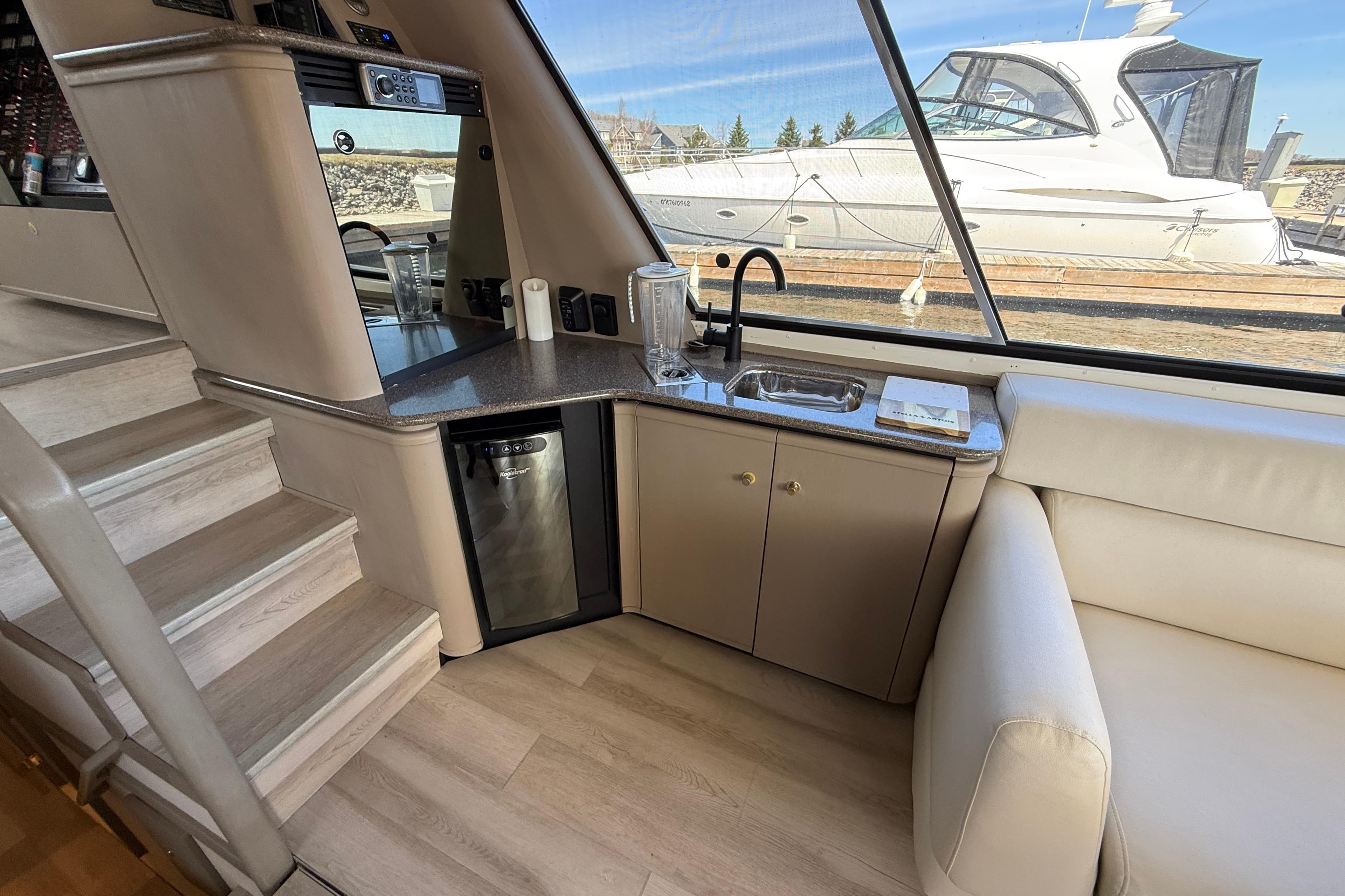 Interior of 1997 Bayliner 4788 Pilot House Motoryacht with kitchenette and seating area.