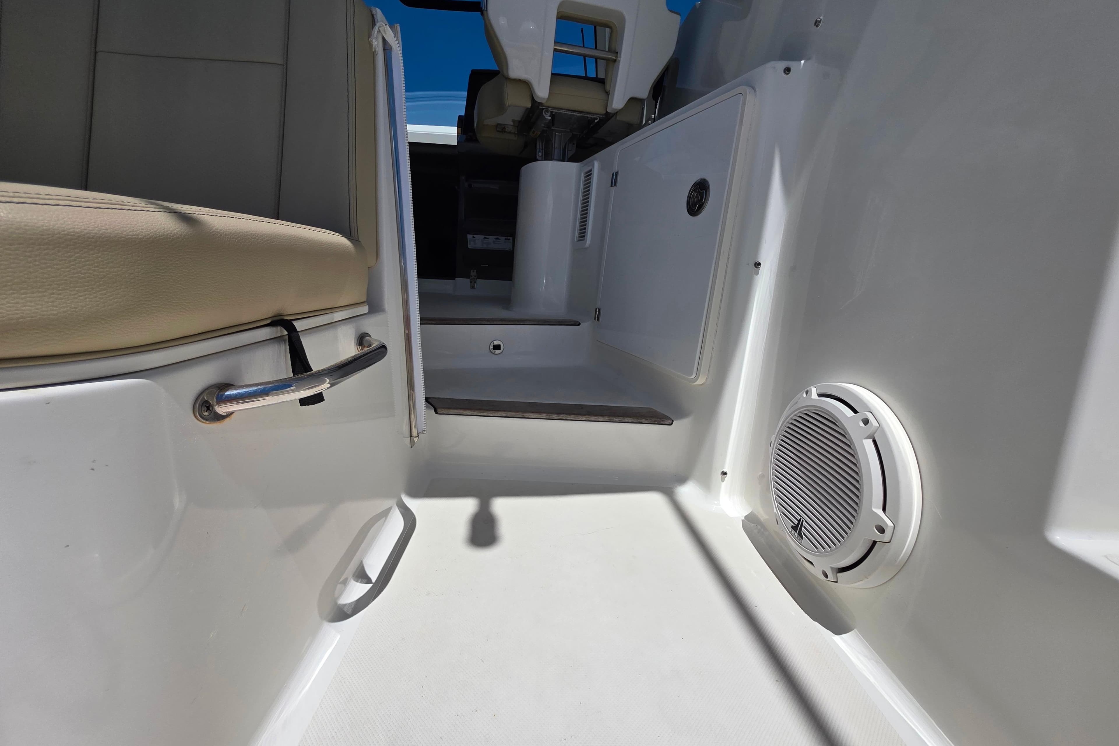 Interior view of 2020 Pursuit OS 325 Offshore boat, featuring seating and speaker.