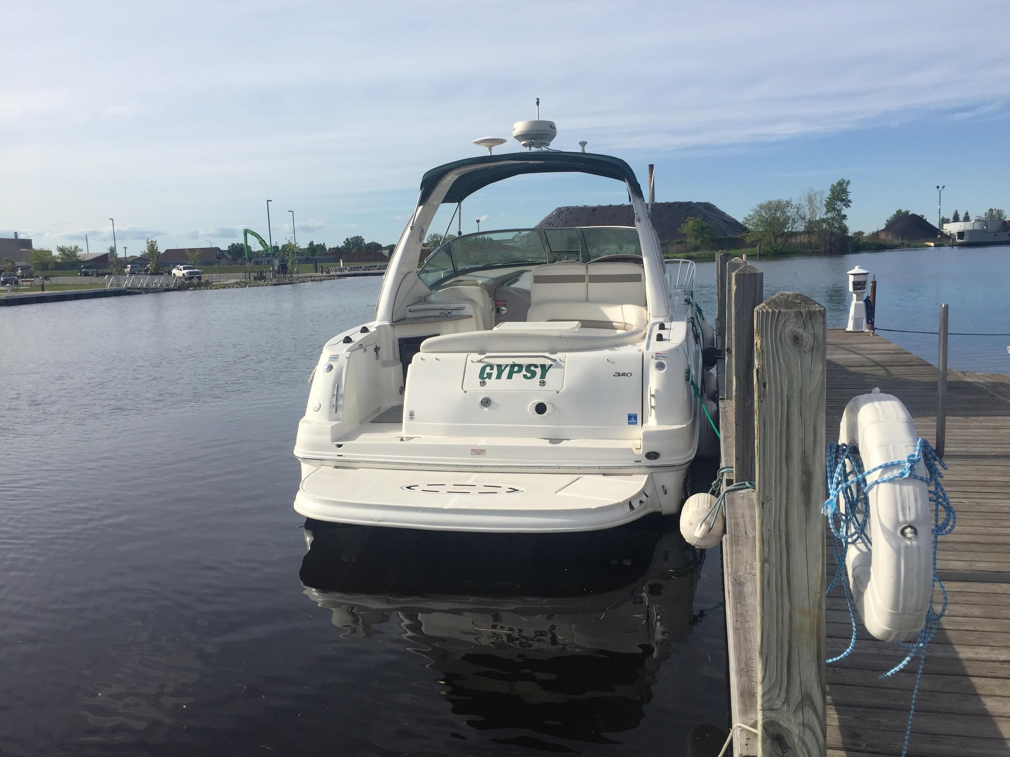 2005 Sea Ray 320 Sundancer docked at a marina.