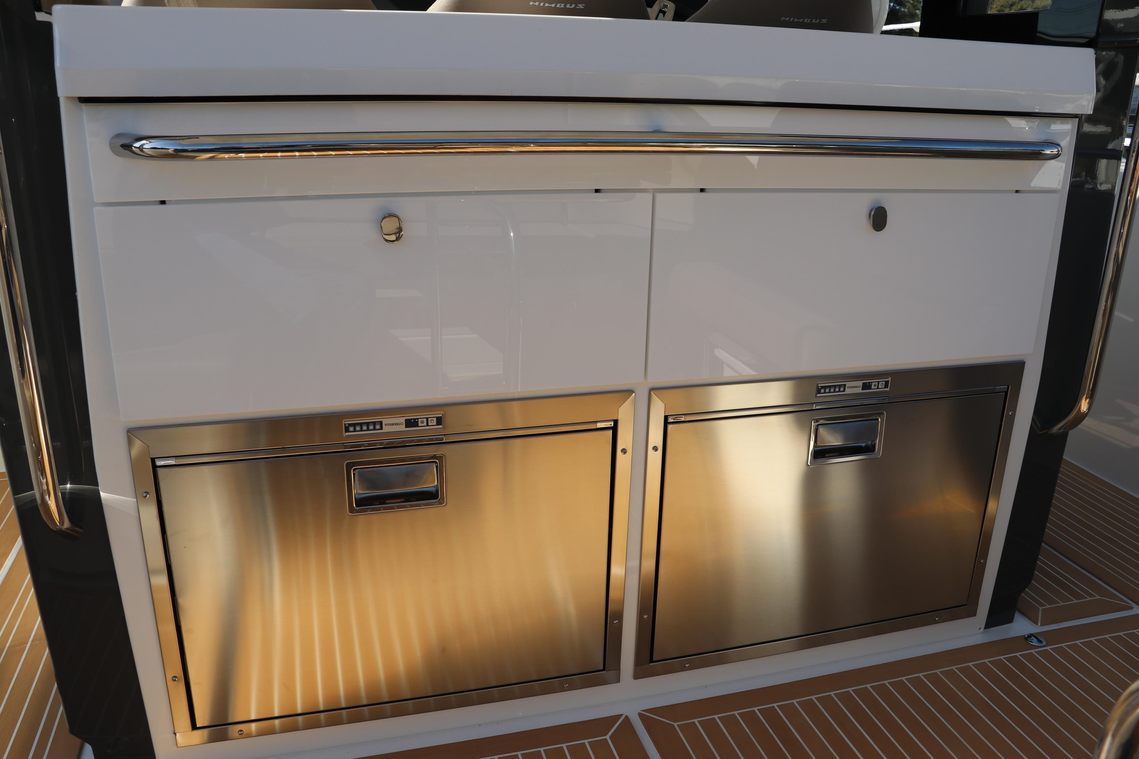 Stainless steel storage compartments on a 2025 Nimbus T11 boat deck.