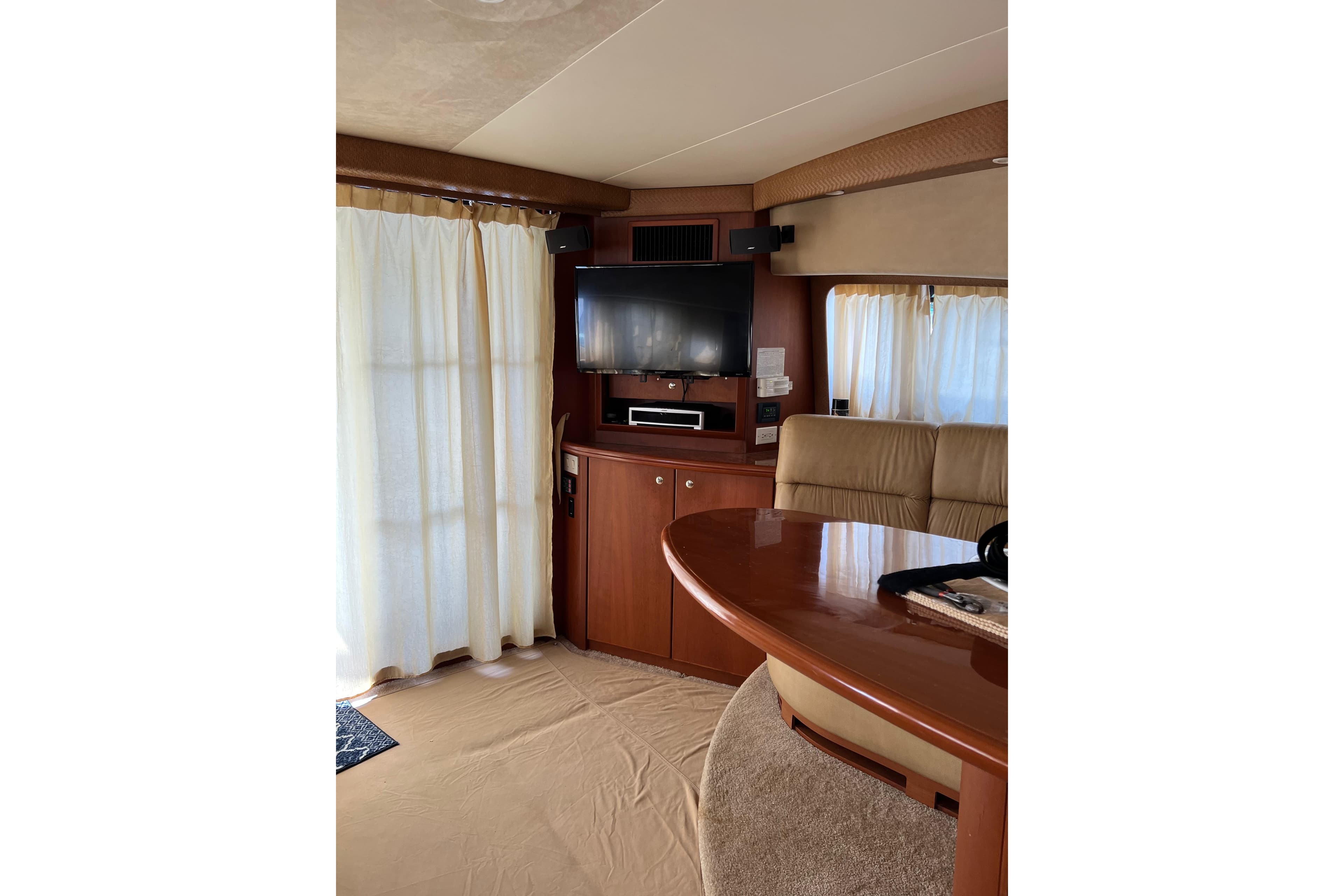 Interior of 2006 Silverton 38 Sport Bridge with TV, curtains, and seating area.