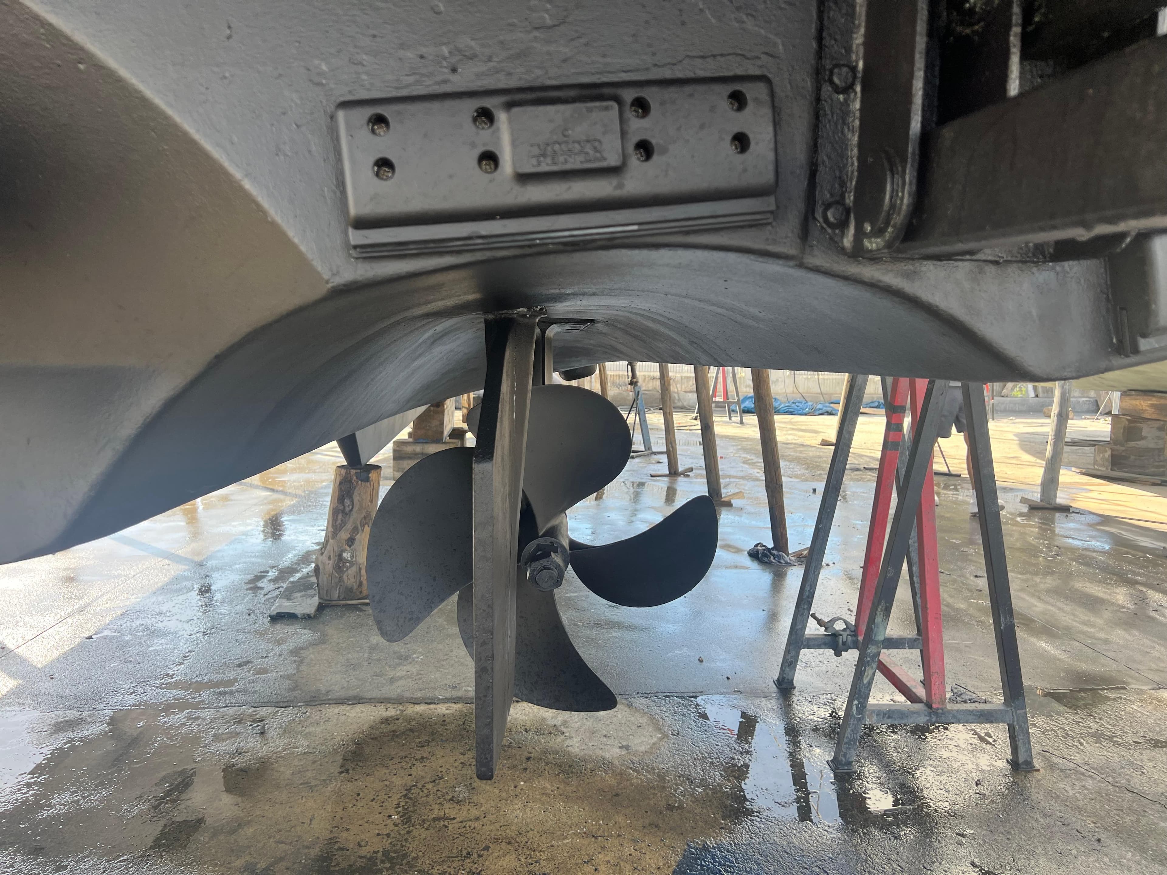 Close-up of a 2008 Riviera 4700 Sport Yacht propeller in a boatyard.