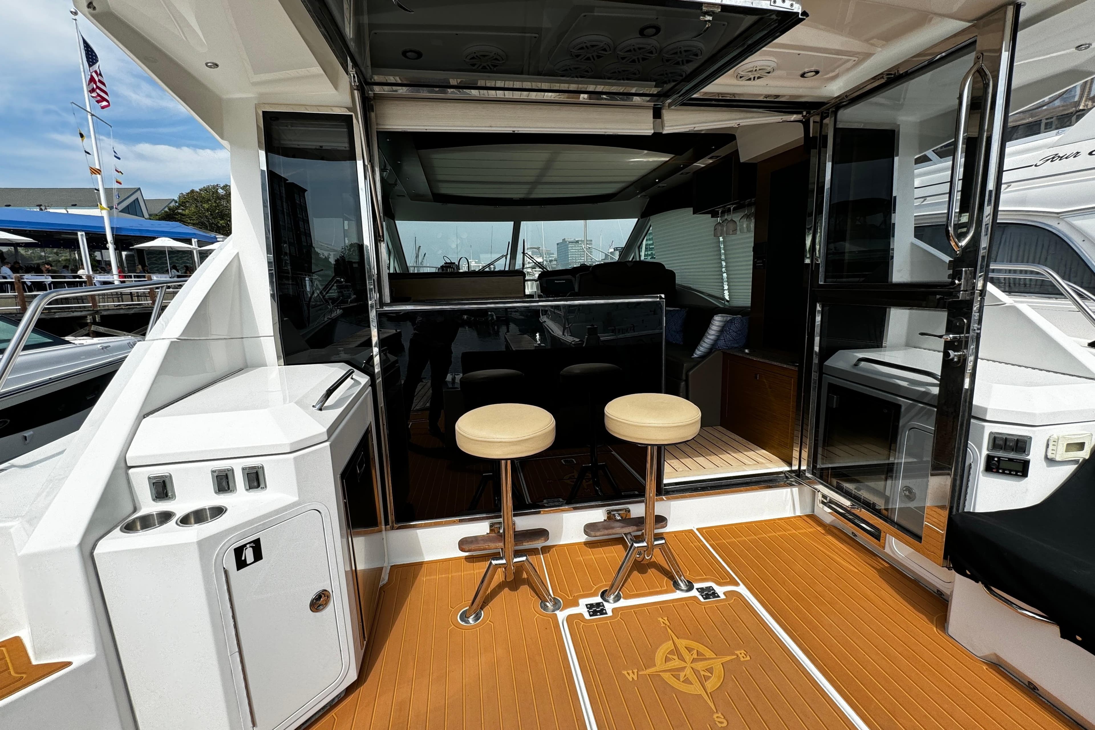 2014 Cruisers Yachts 45 Cantius cockpit with bar stools and sliding glass doors.