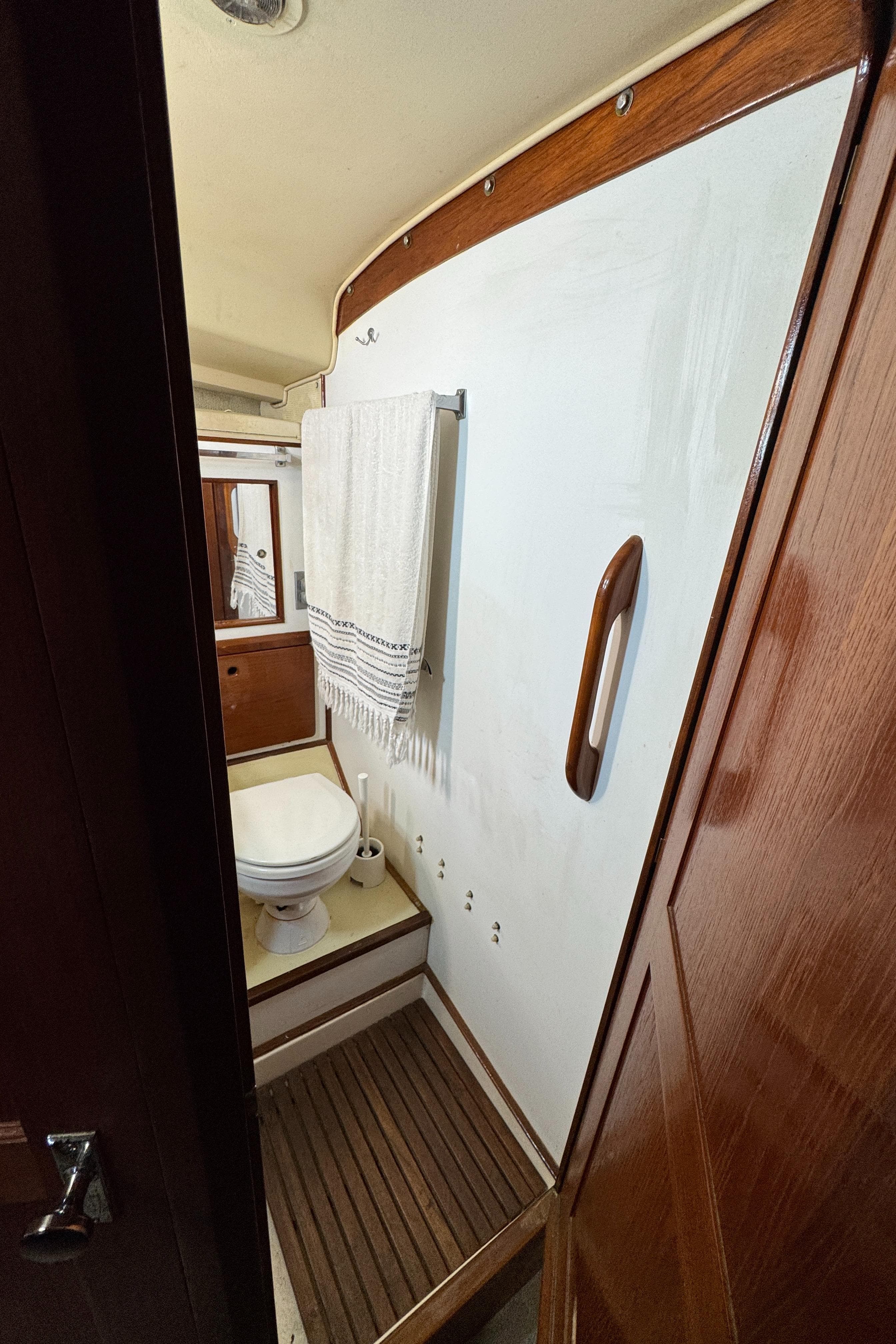 1981 Morgan 416 Out Island yacht bathroom with wooden accents and towel rack.