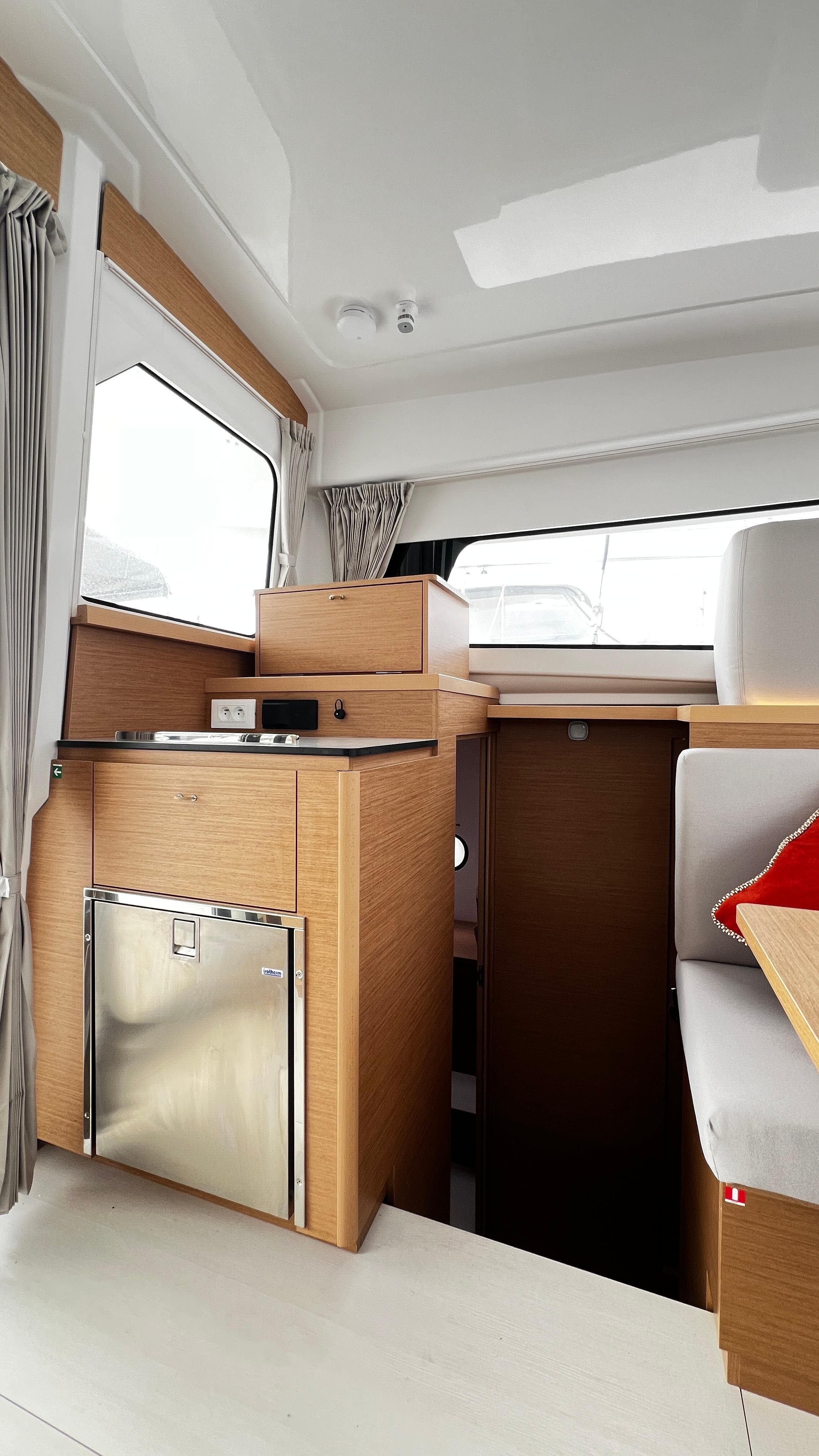 Modern interior of 2023 Excess 11 yacht with sleek wood finishes and compact design.