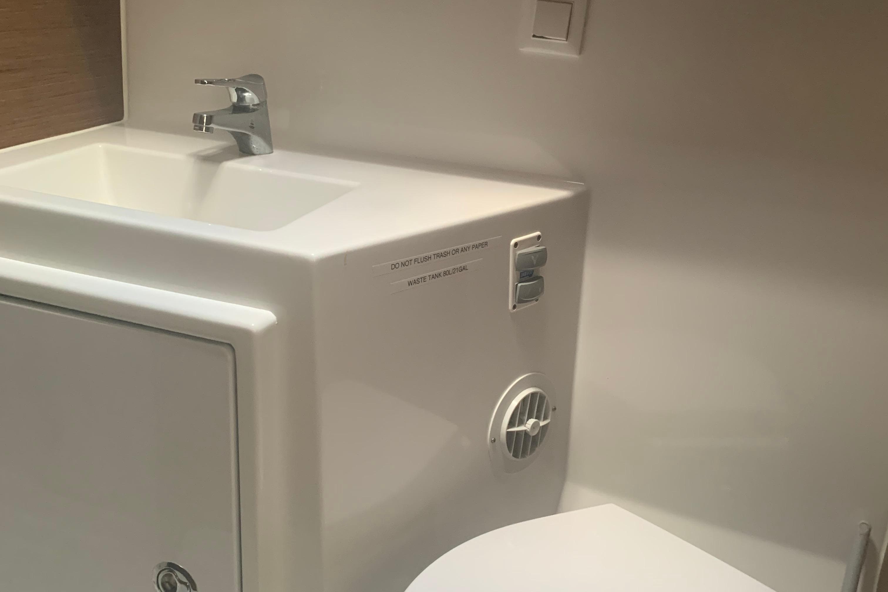 Modern bathroom in 2019 Lagoon 42 yacht with sink and toilet.
