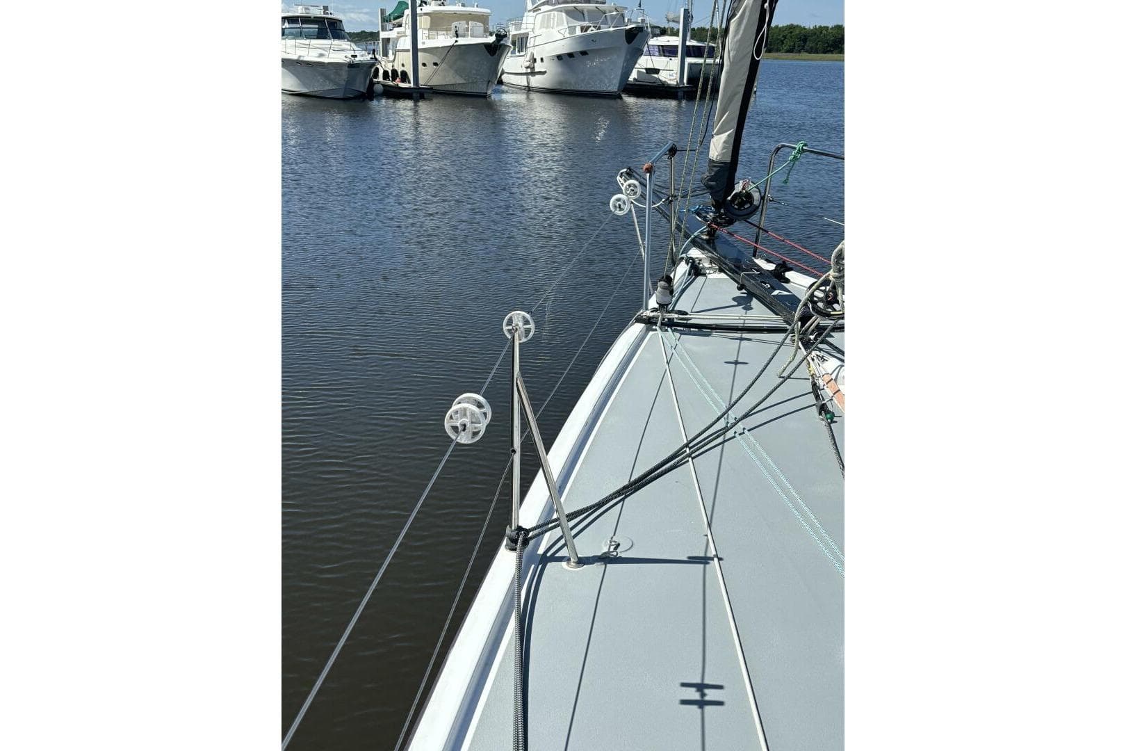 Sailboat deck view of 2009 Class 40 Akilaria RC2 in marina.