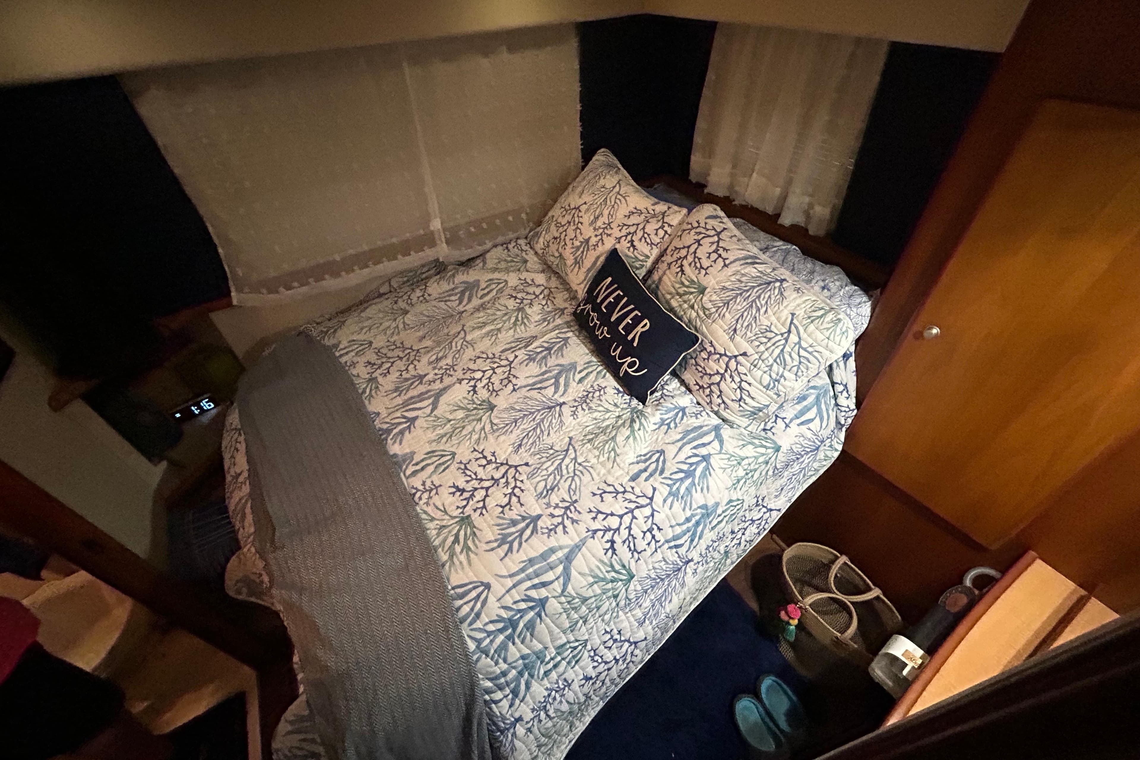 Cozy bedroom in 1999 Silverton 352 Motor Yacht with nautical-themed bedding and decor.