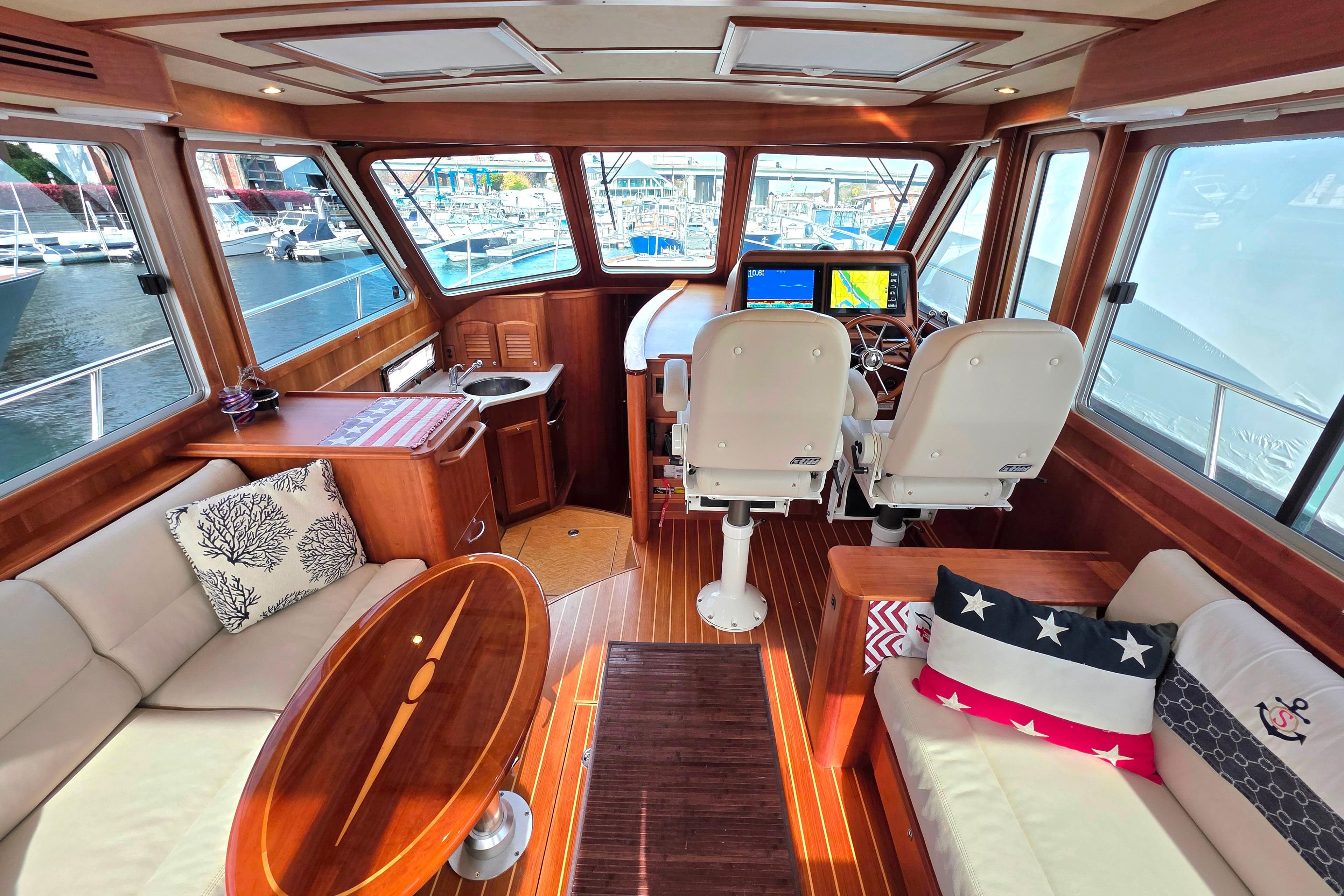 Luxurious 2017 Sabre 42 Salon Express interior with helm, seating, and nautical decor.