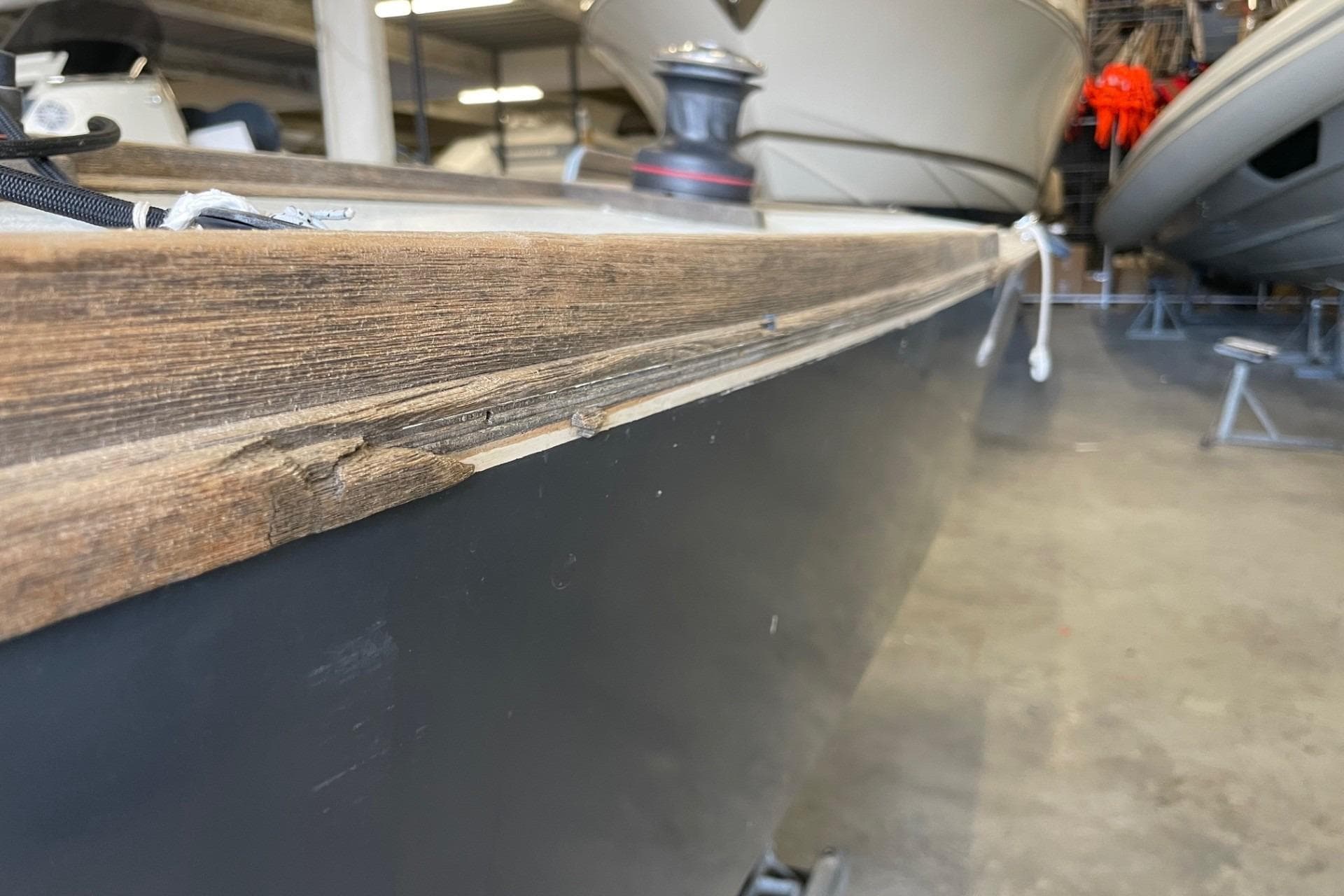 Close-up of 2015 Chantier des Ileaux X.0 boat hull in a storage facility.