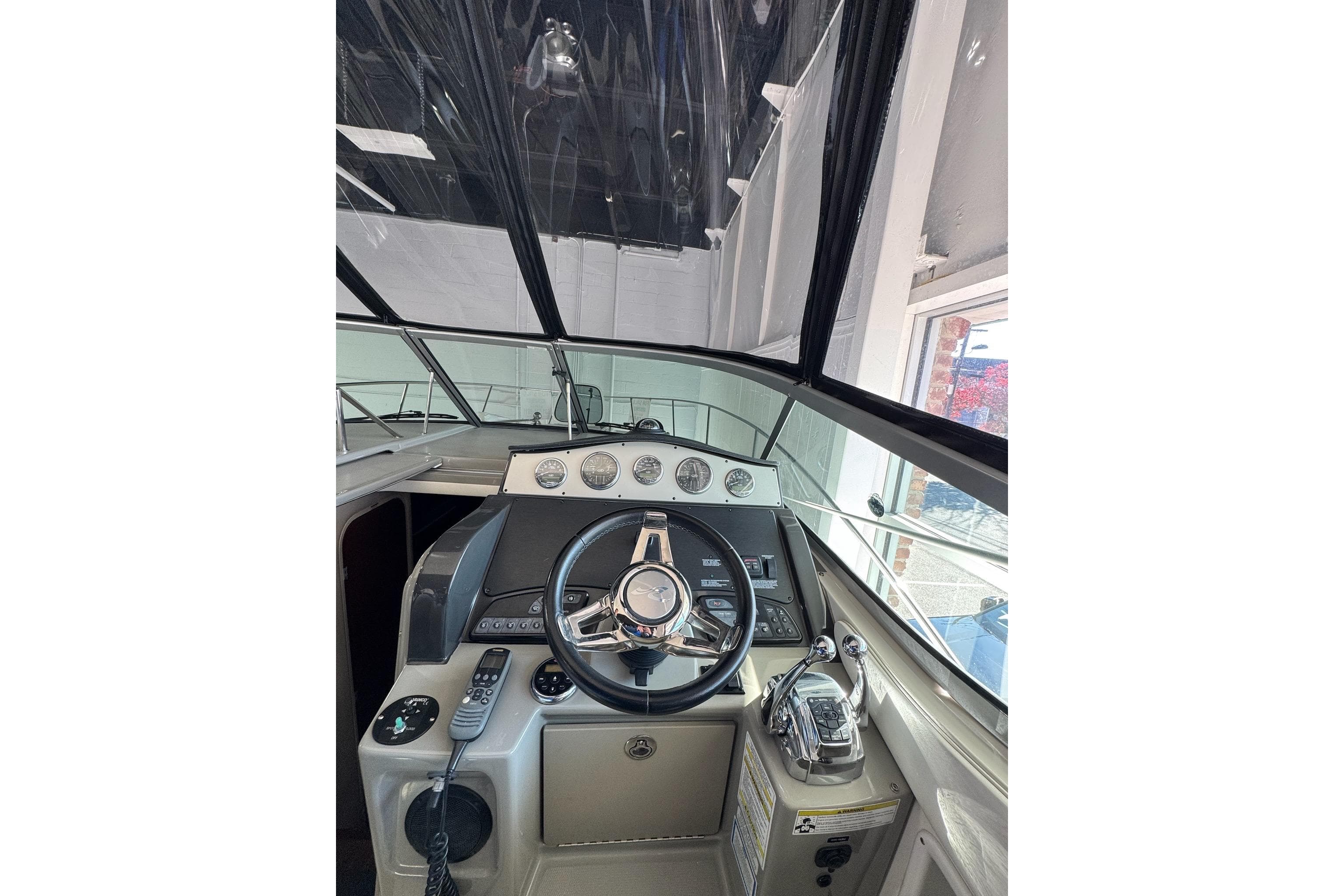 2014 Searay 330 Sundancer boat helm with steering wheel and control panel.