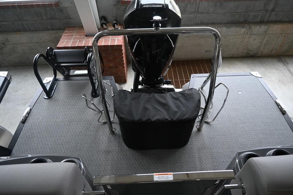 2026 Evotti 723QL boat deck with motor, railing, and seating in a garage setting.