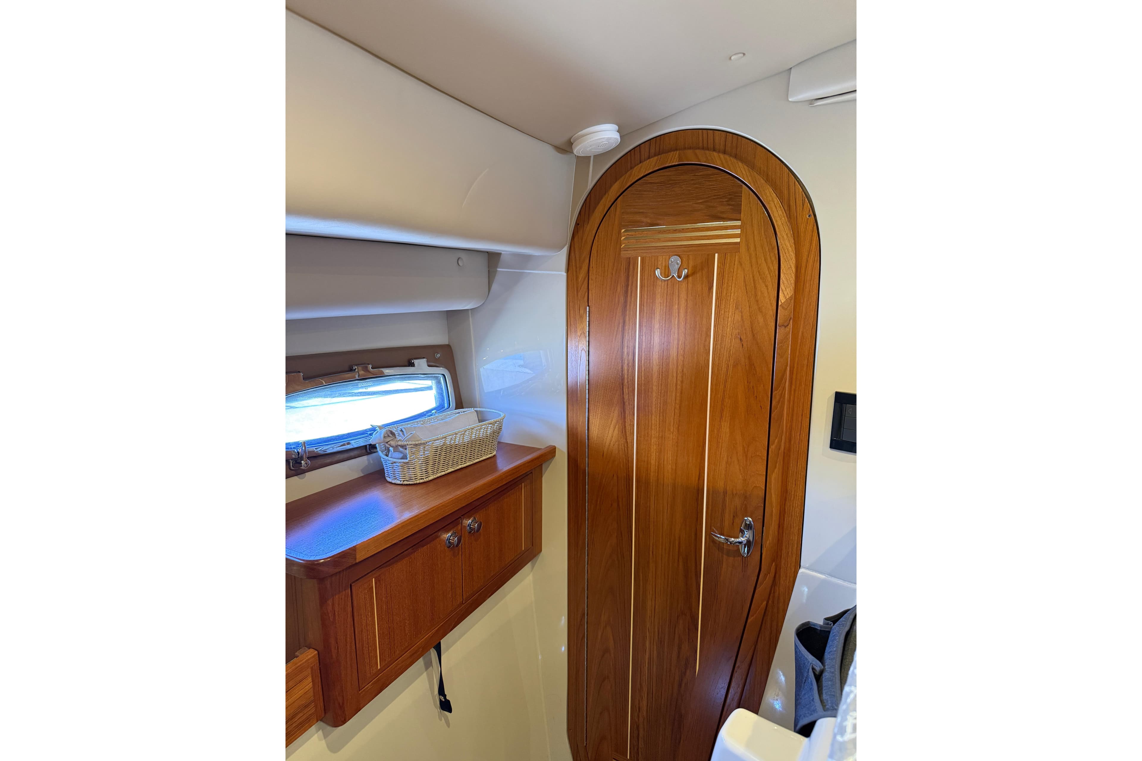 Interior of 2017 Aspen C120 boat with wooden door and storage shelf.