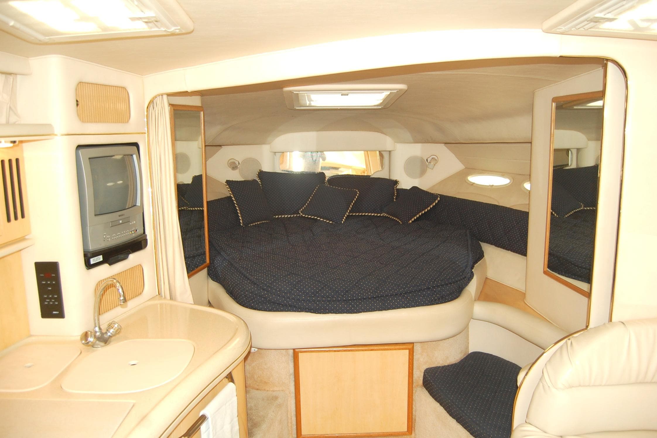 Interior of 2000 Sea Ray 340 Sundancer yacht with cozy bed and compact amenities.