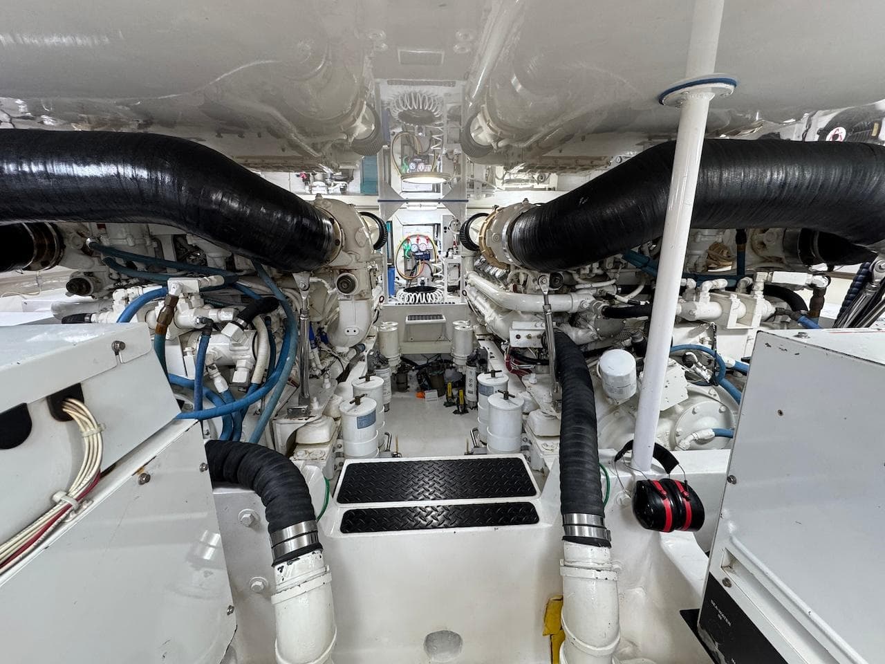 Engine room of a 2007 Viking 52 Convertibles yacht, showcasing complex machinery and piping.