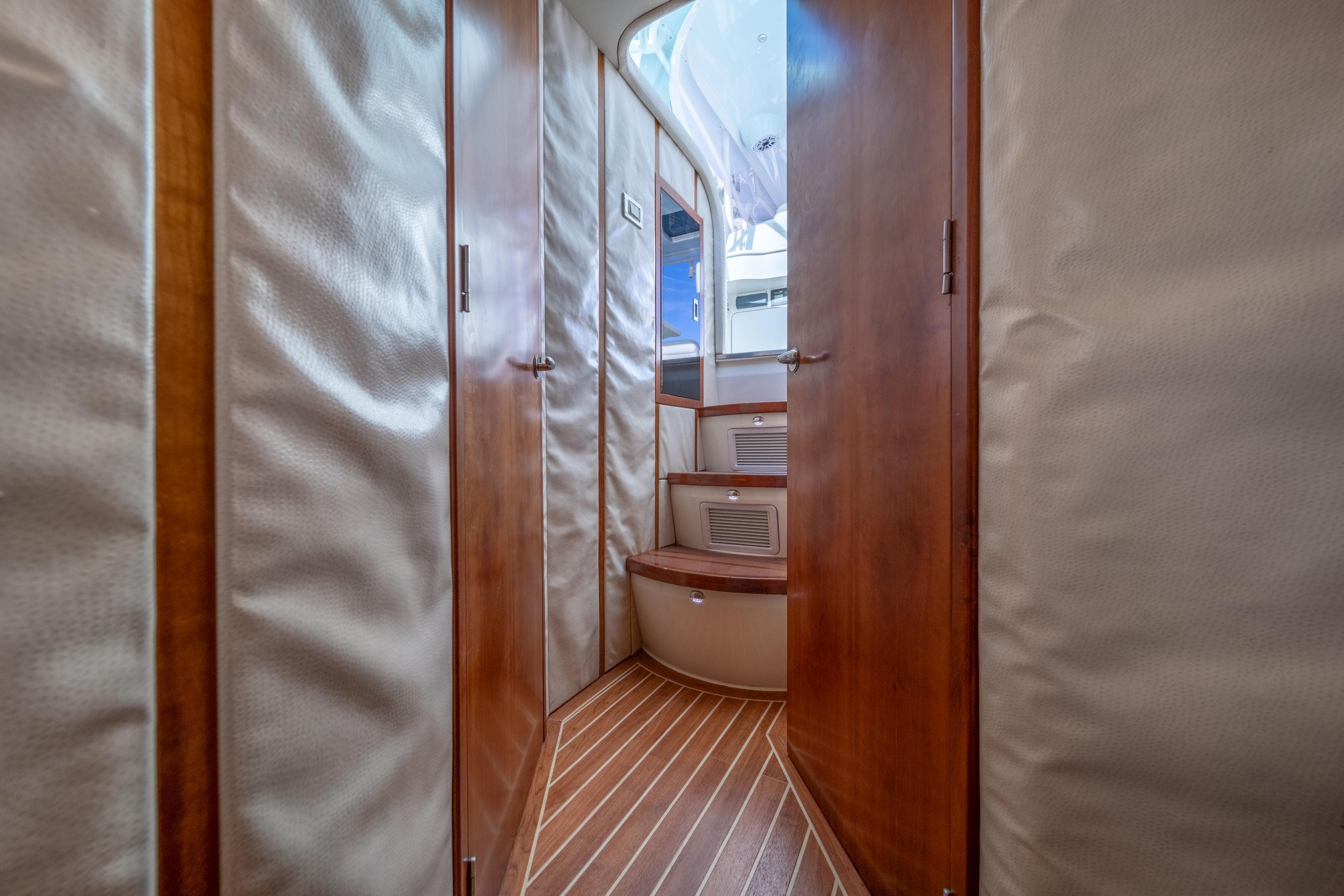 Interior of 2011 SeaVee 430 Sport Express with wood paneling and steps.
