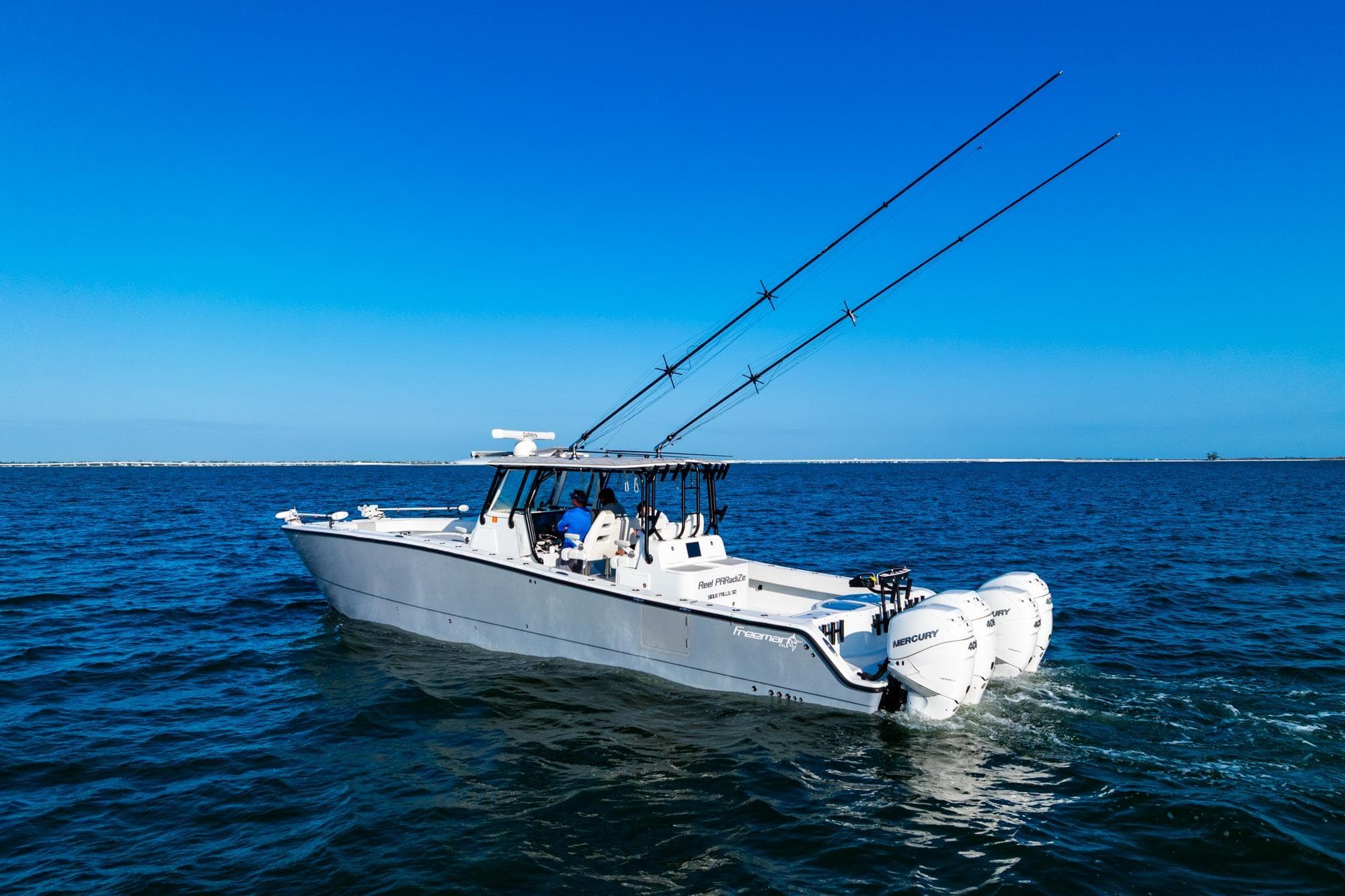 2022 Freeman 42LR boat with fishing rods on open water under clear blue sky.