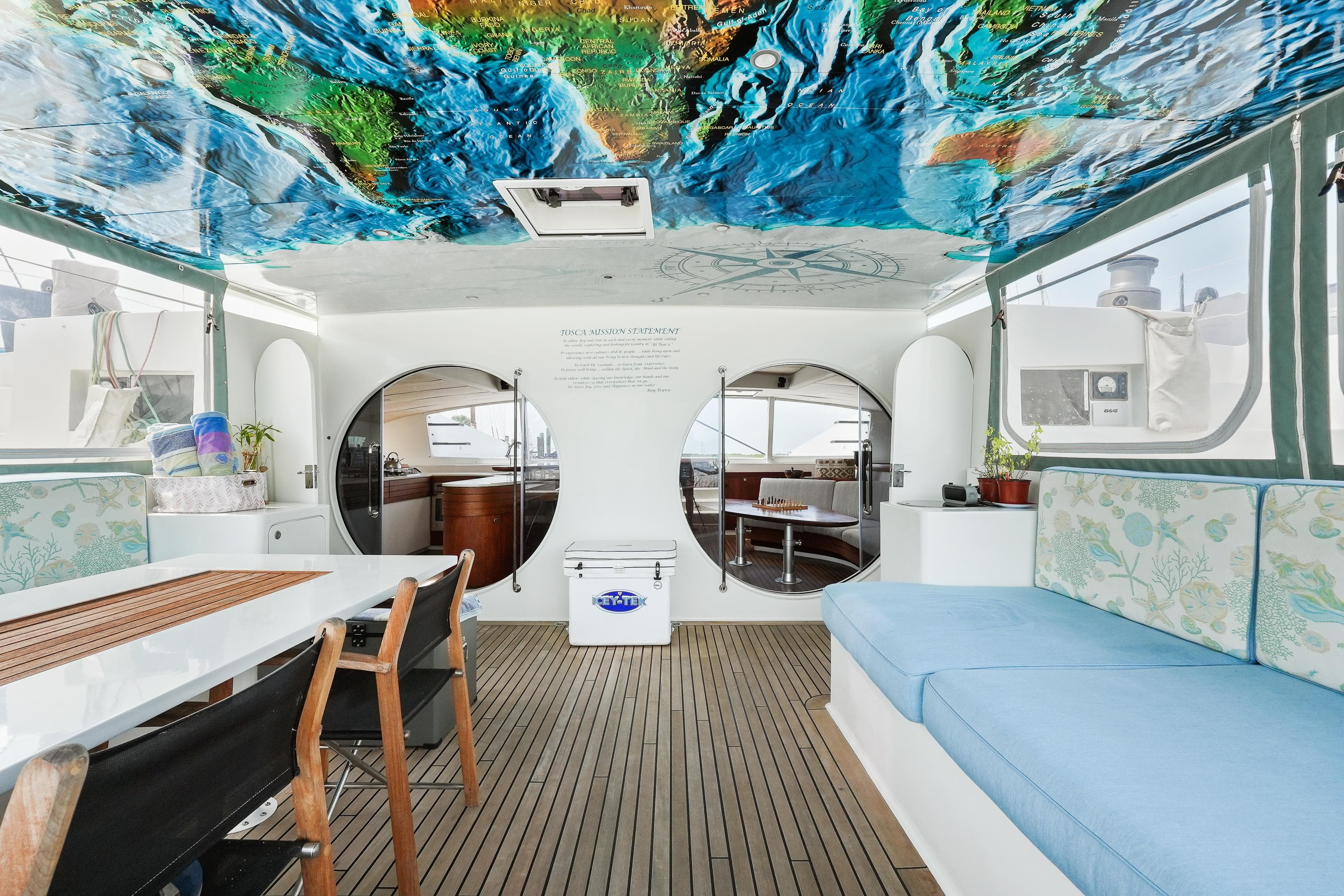 Interior of 2011 Moxie 61 yacht with vibrant ceiling art and modern furnishings.