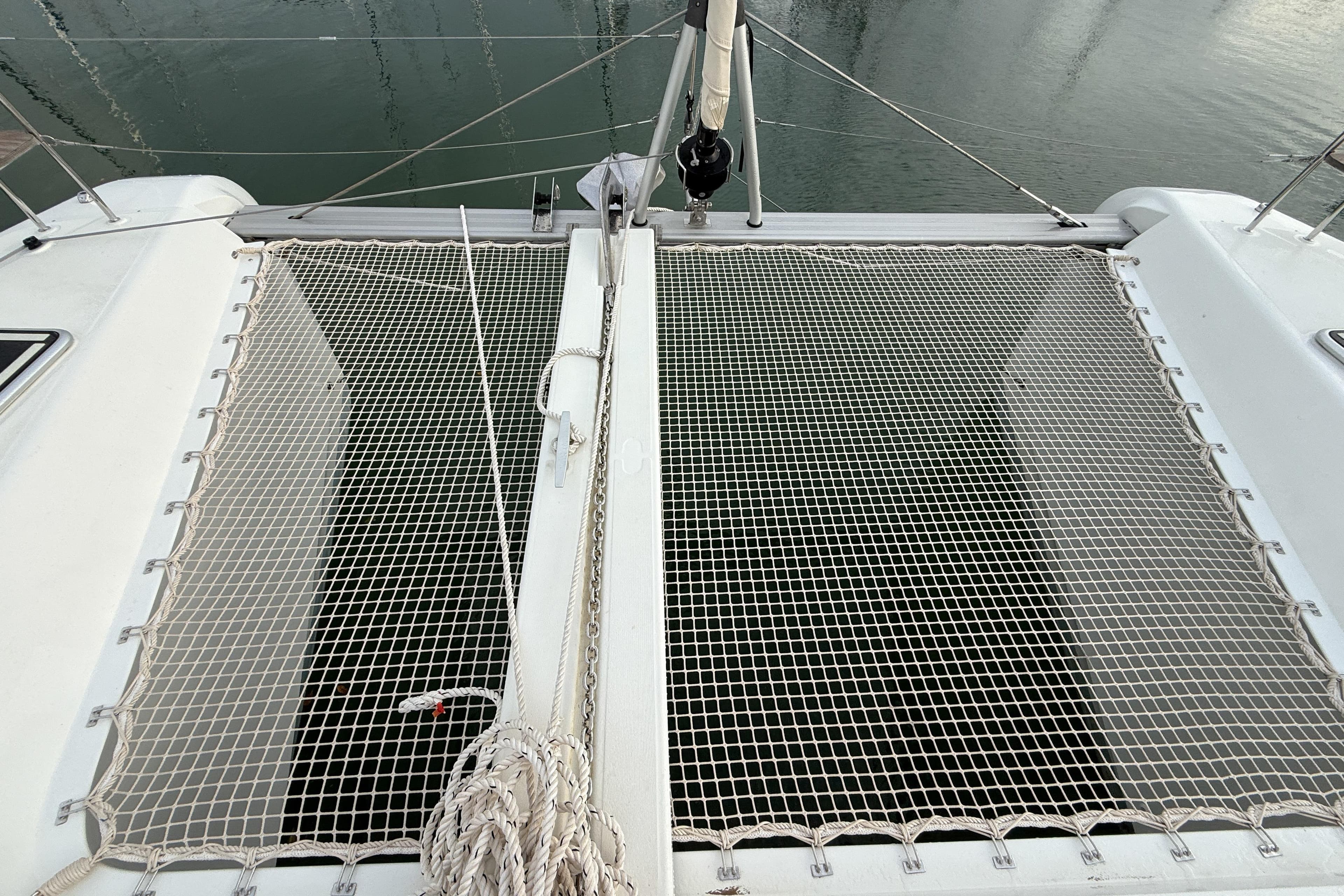 2024 Lagoon 42 catamaran trampoline netting over water.