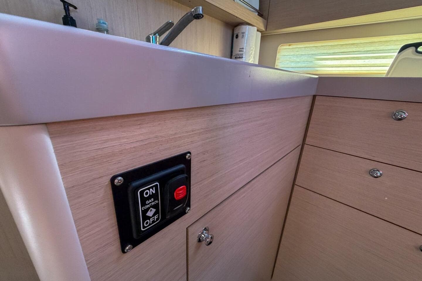 Interior of 2022 Beneteau Oceanis 40.1 yacht kitchen with gas control switch.