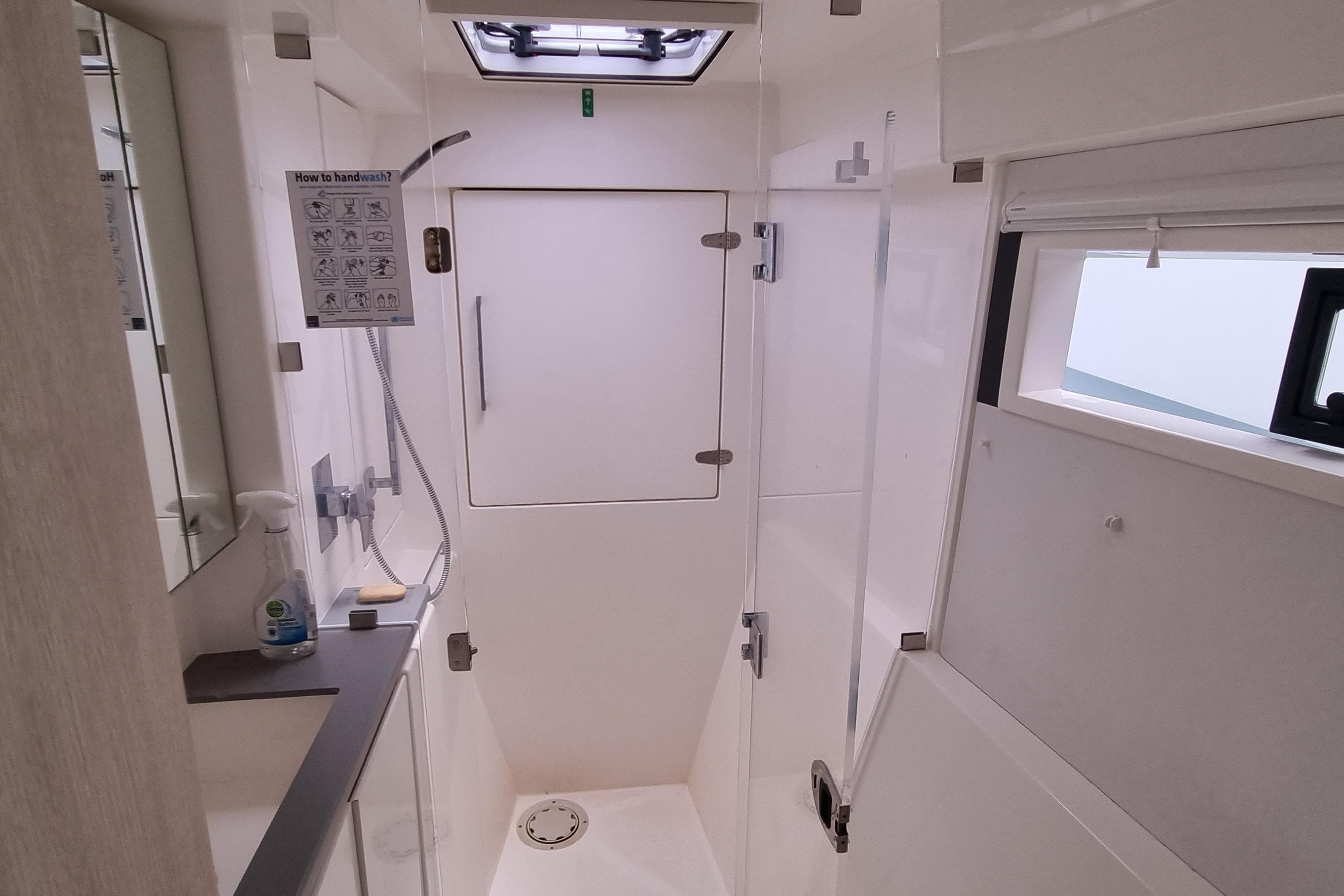 Modern bathroom interior of 2020 Leopard 40 yacht, featuring shower and sink area.