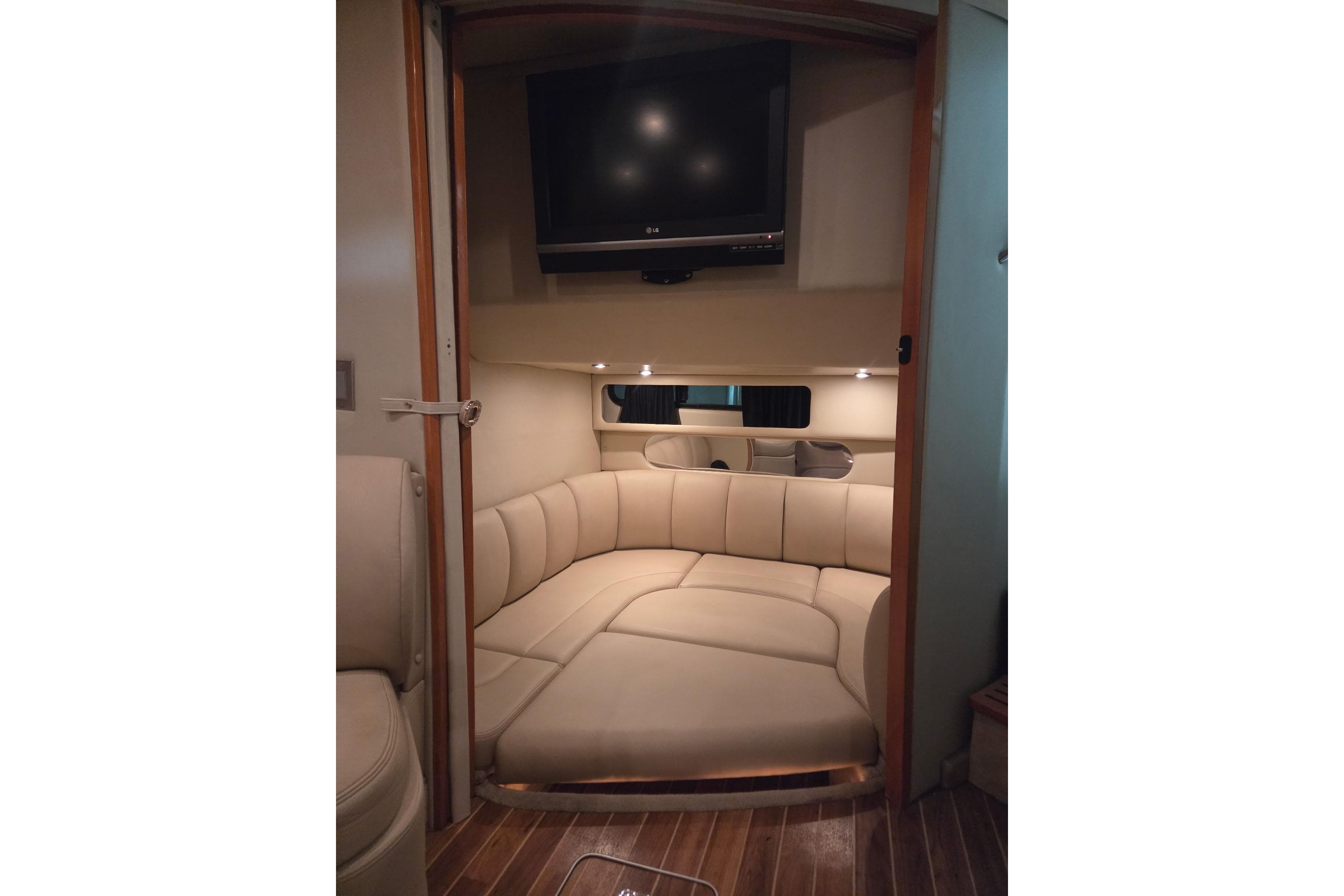 Interior of 2008 Chaparral Signature 350 yacht with cozy seating and mounted TV.