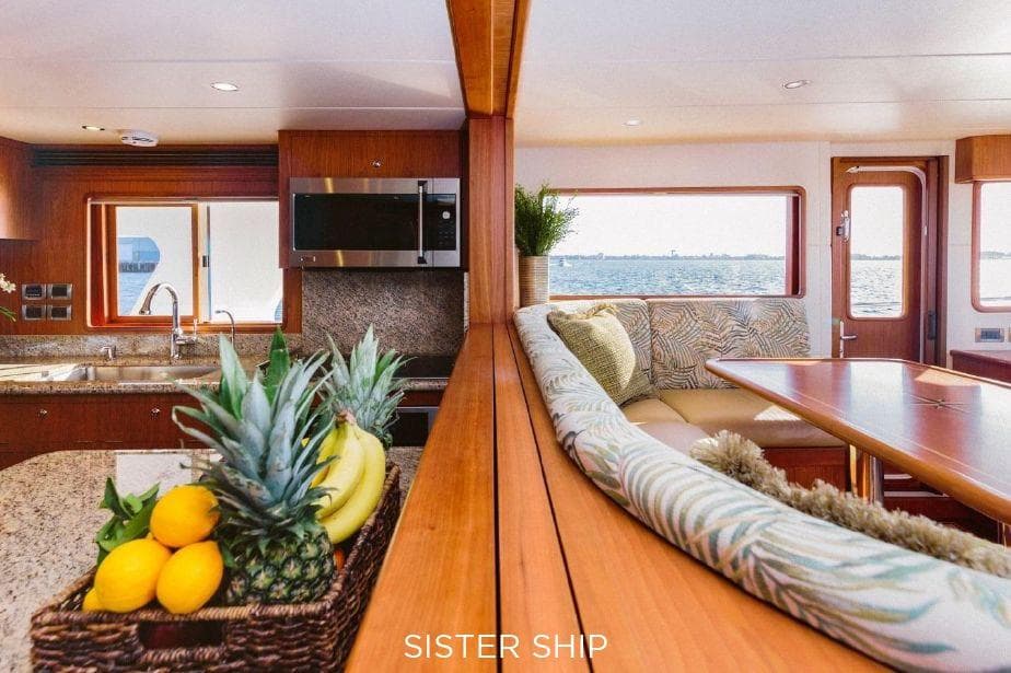 Luxurious interior of 2027 Outer Reef Yachts 880 Cockpit Motoryacht with kitchen and dining area.