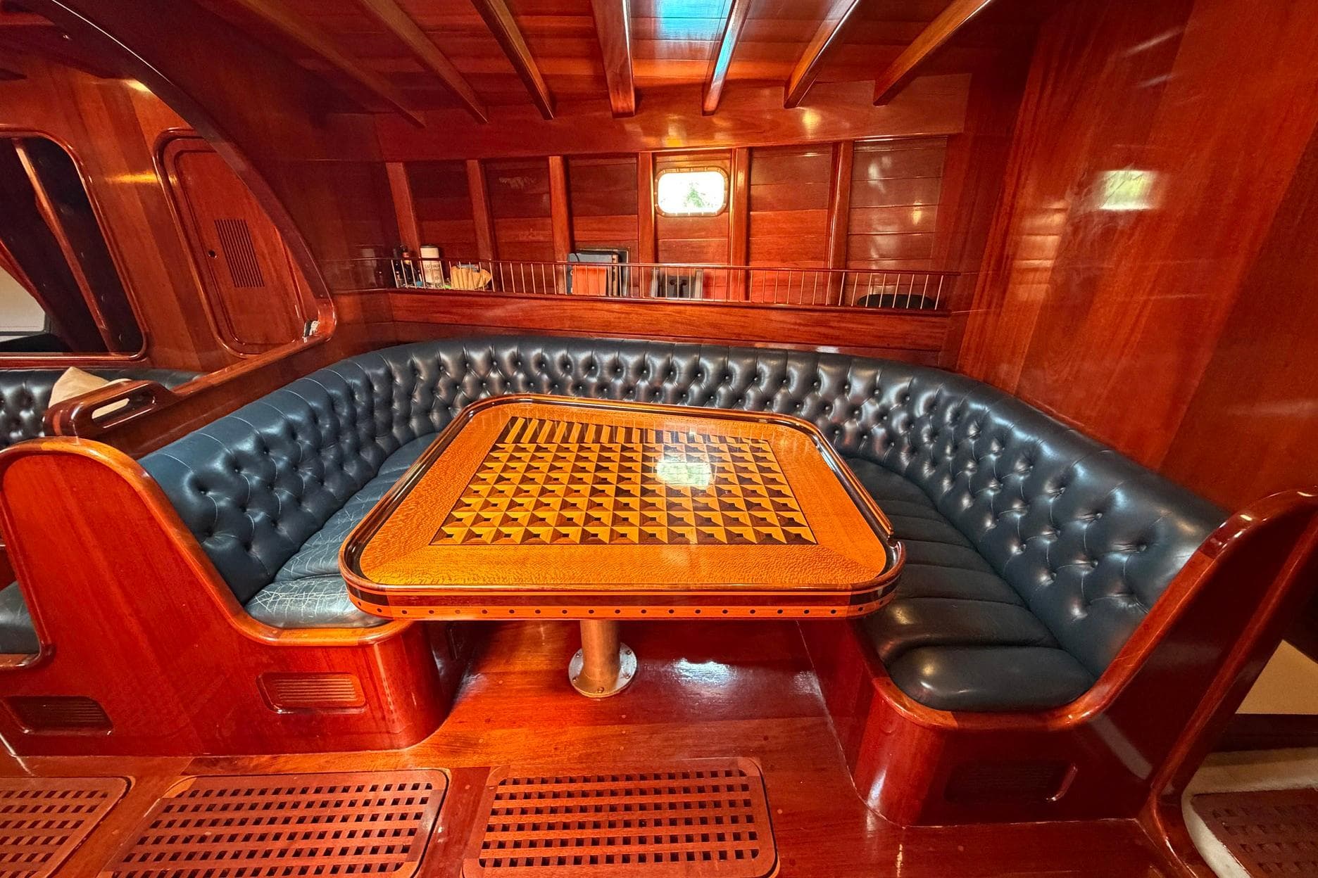 Luxurious 1992 Vic Carpenter Custom yacht interior with elegant wood and leather seating.