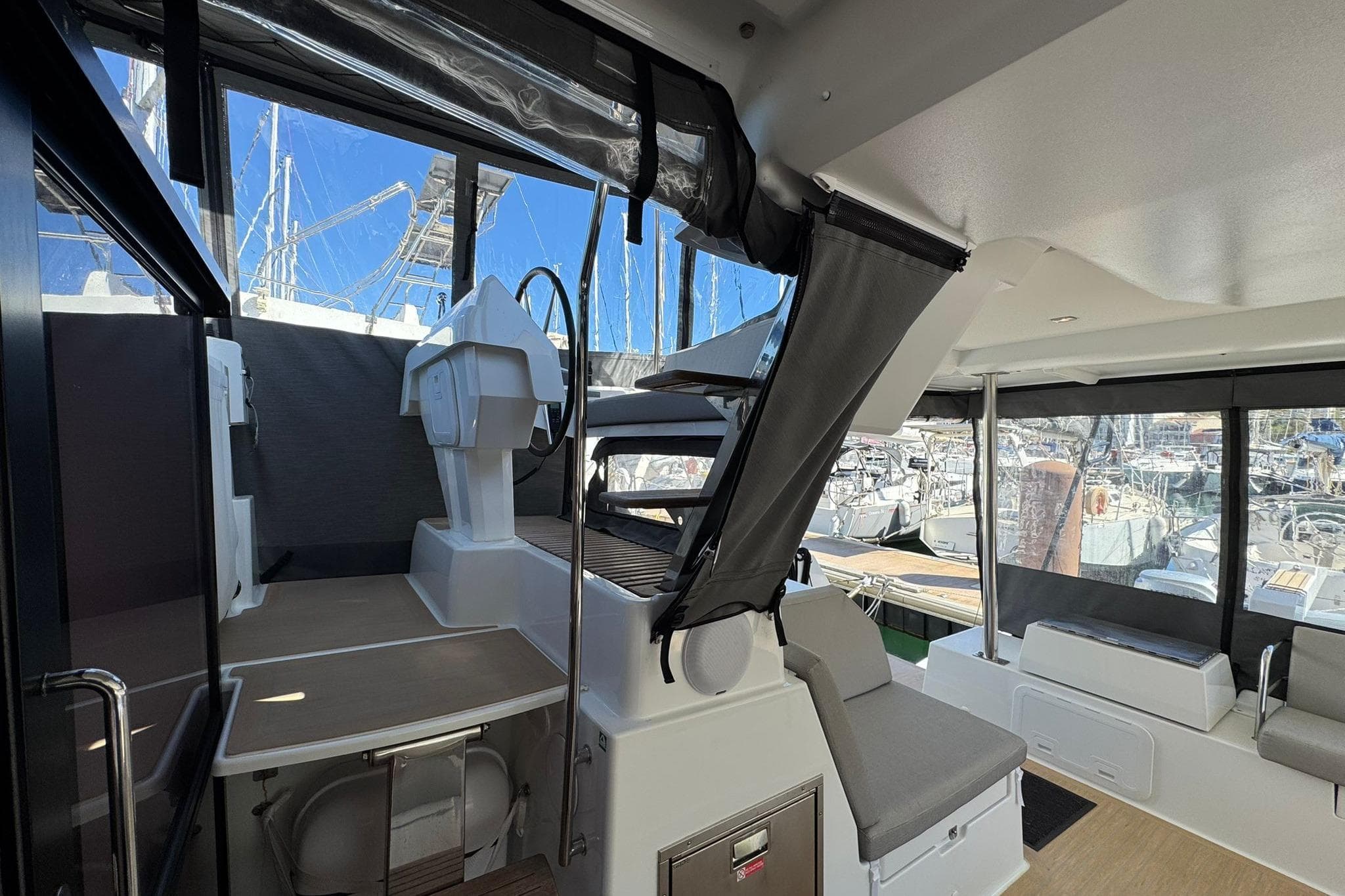 Interior view of 2025 Fountaine Pajot Tanna 47 catamaran, showcasing seating and helm station.