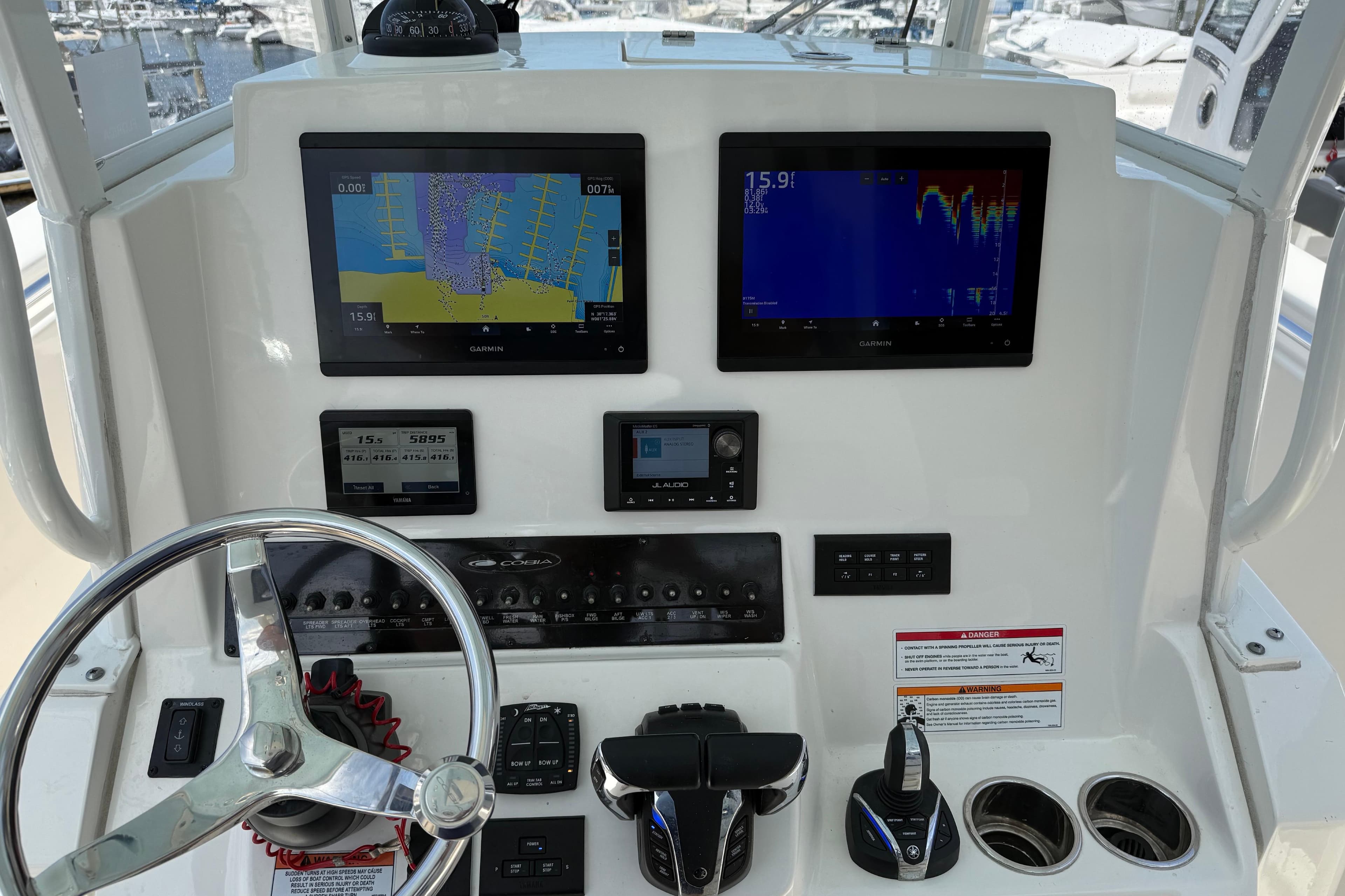 2023 Cobia 301 Center Console dashboard with Garmin displays and steering wheel.