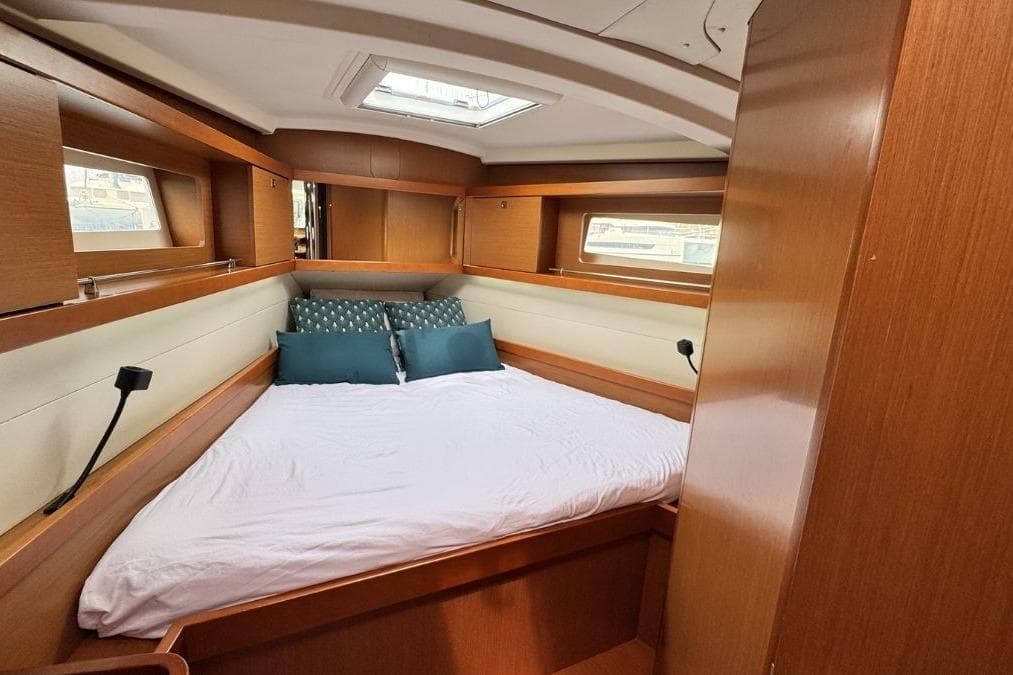Cozy cabin interior of 2012 Beneteau Oceanis 41 sailboat with comfortable bedding.