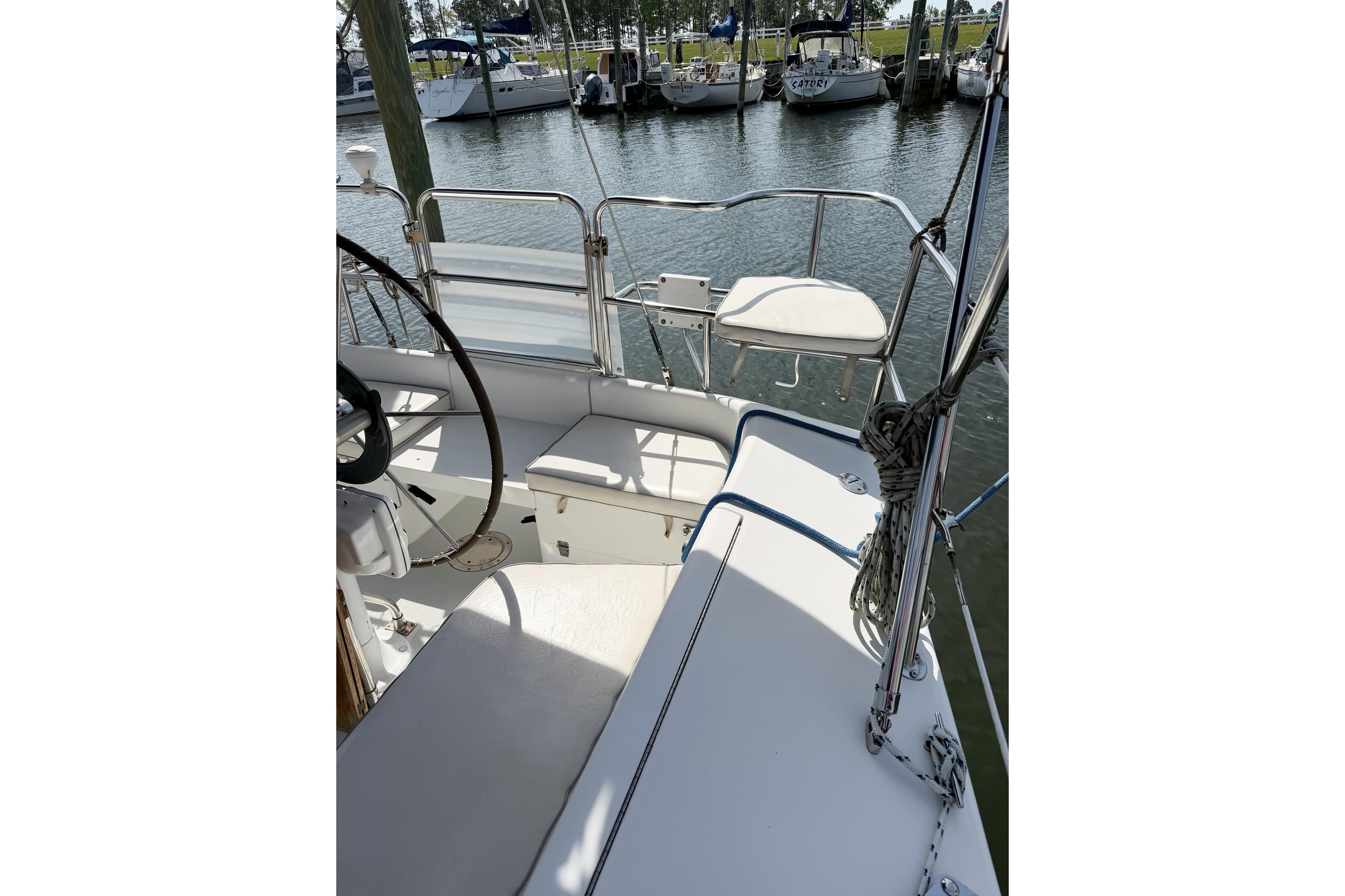 Cockpit view of a 2003 Catalina 34 MkII sailboat docked at a marina.